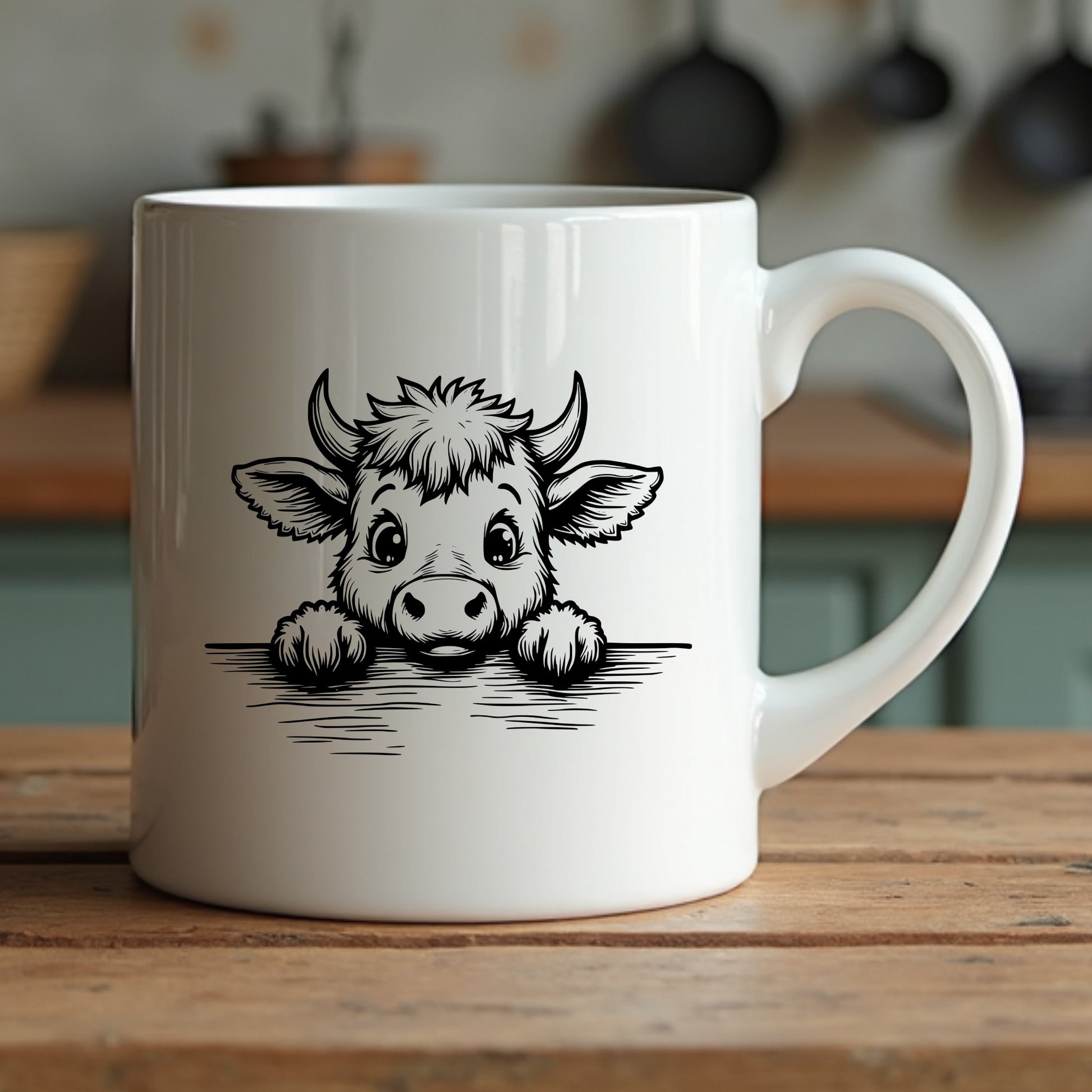 White mug with a highland cow illustration sitting on a wooden surface