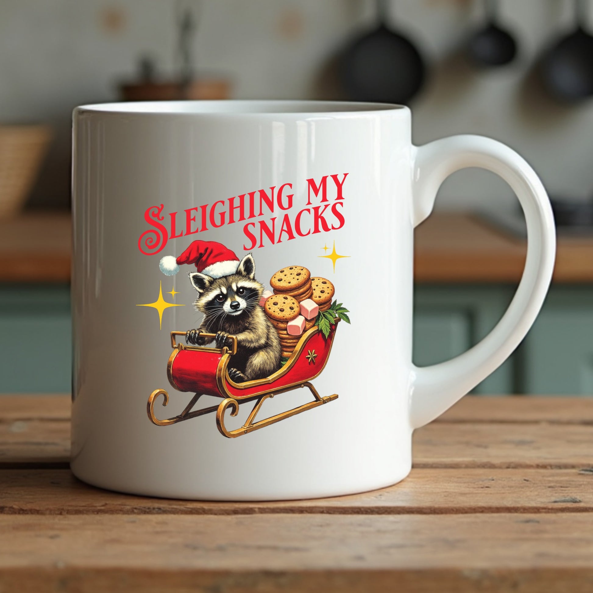 White mug with a Christmas-themed design of a raccoon in a sleigh with cookies, on a wooden surface.