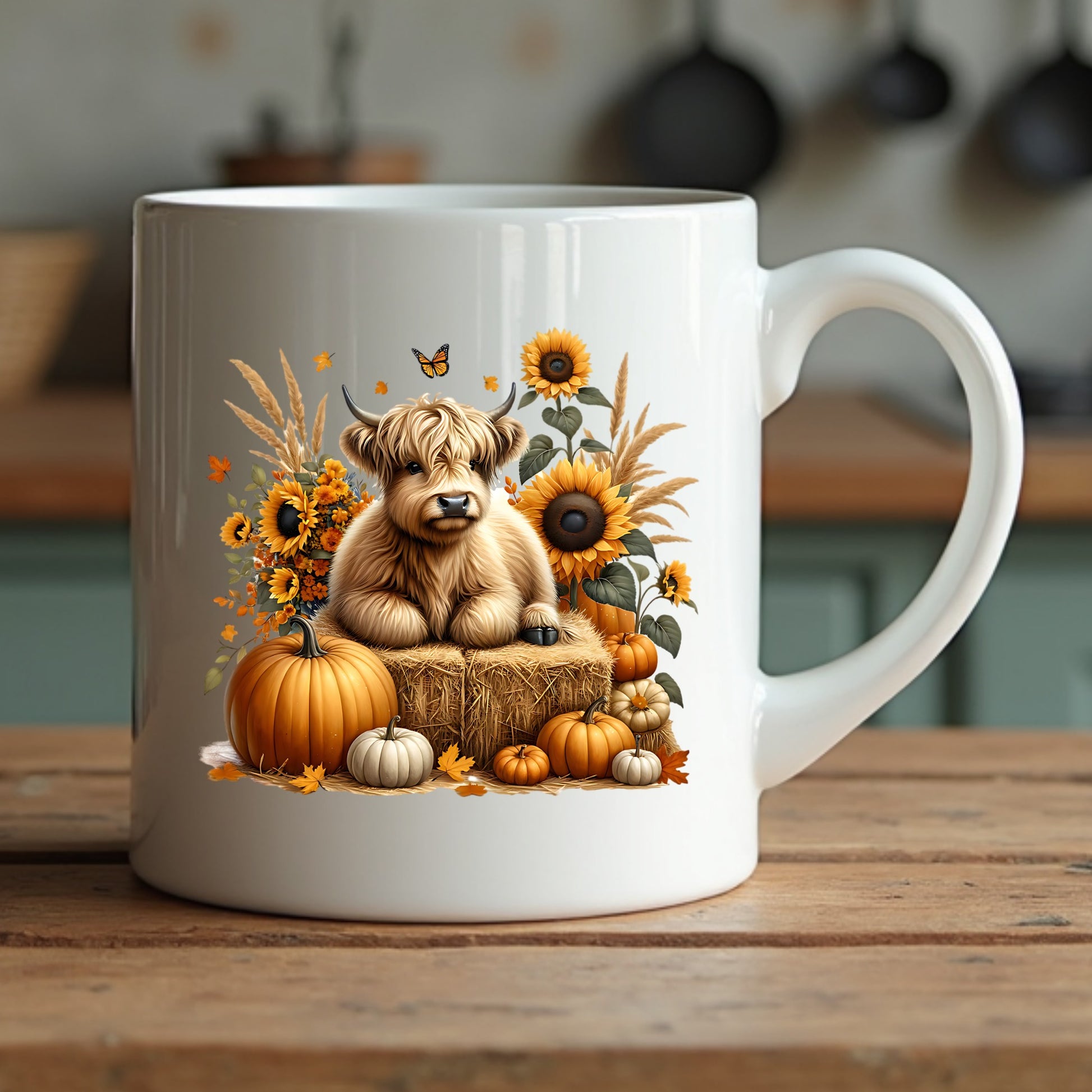 White mug with a highland cow and autumn-themed design sitting on a wooden surface.