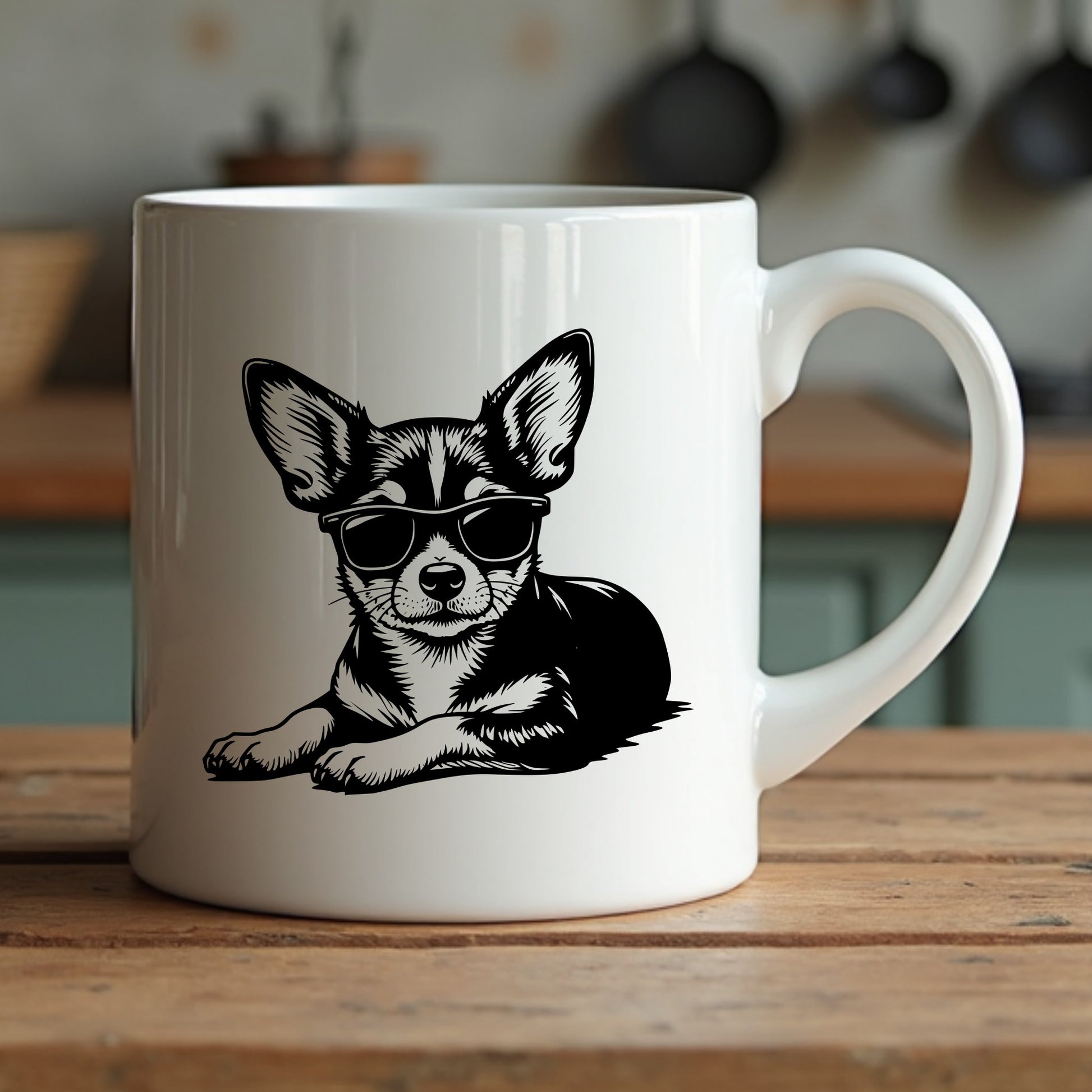 White mug with a black and white illustration of a chihuahua wearing sunglasses on a wooden surface.
