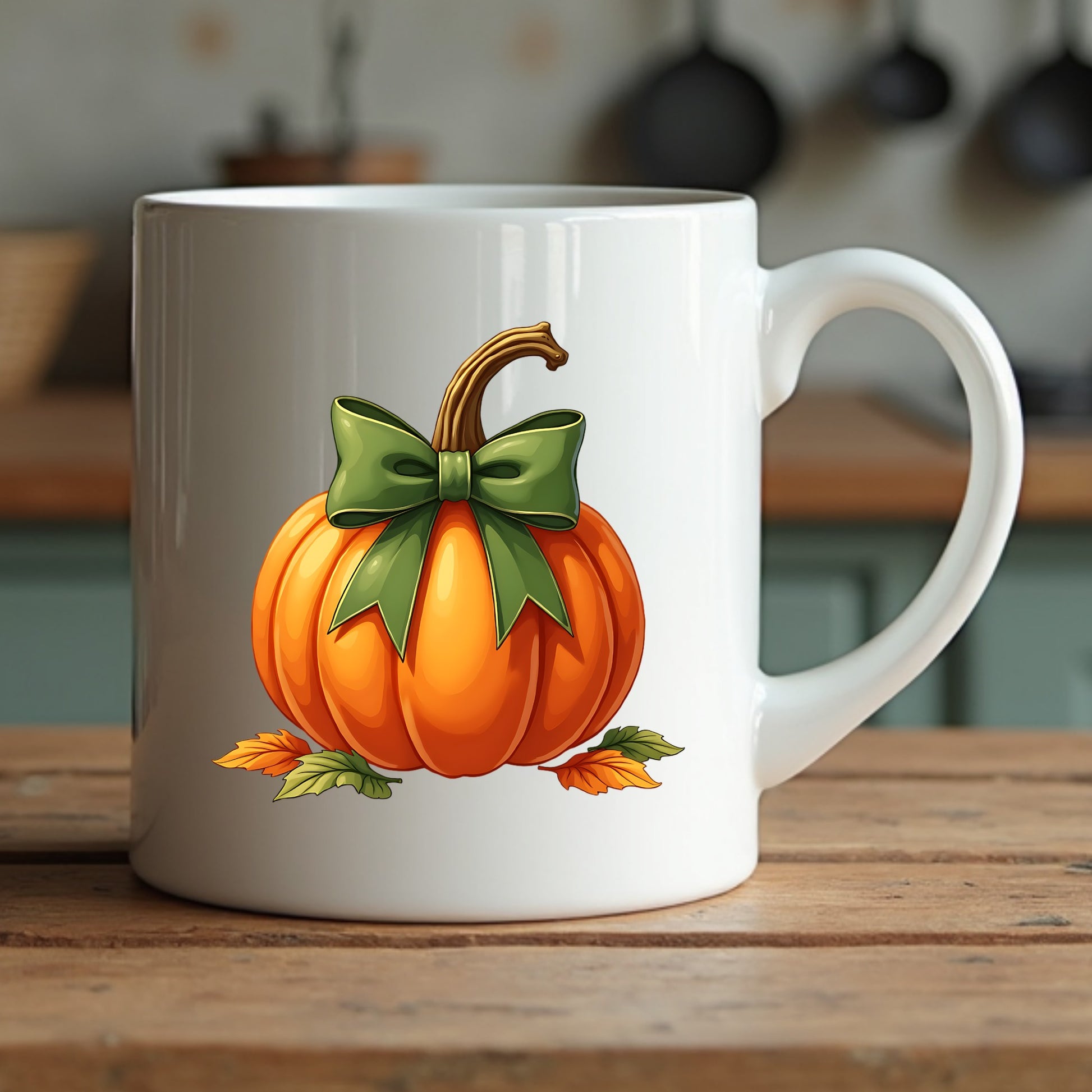 White mug with a pumpkin design featuring a green bow sitting on a wooden surface.