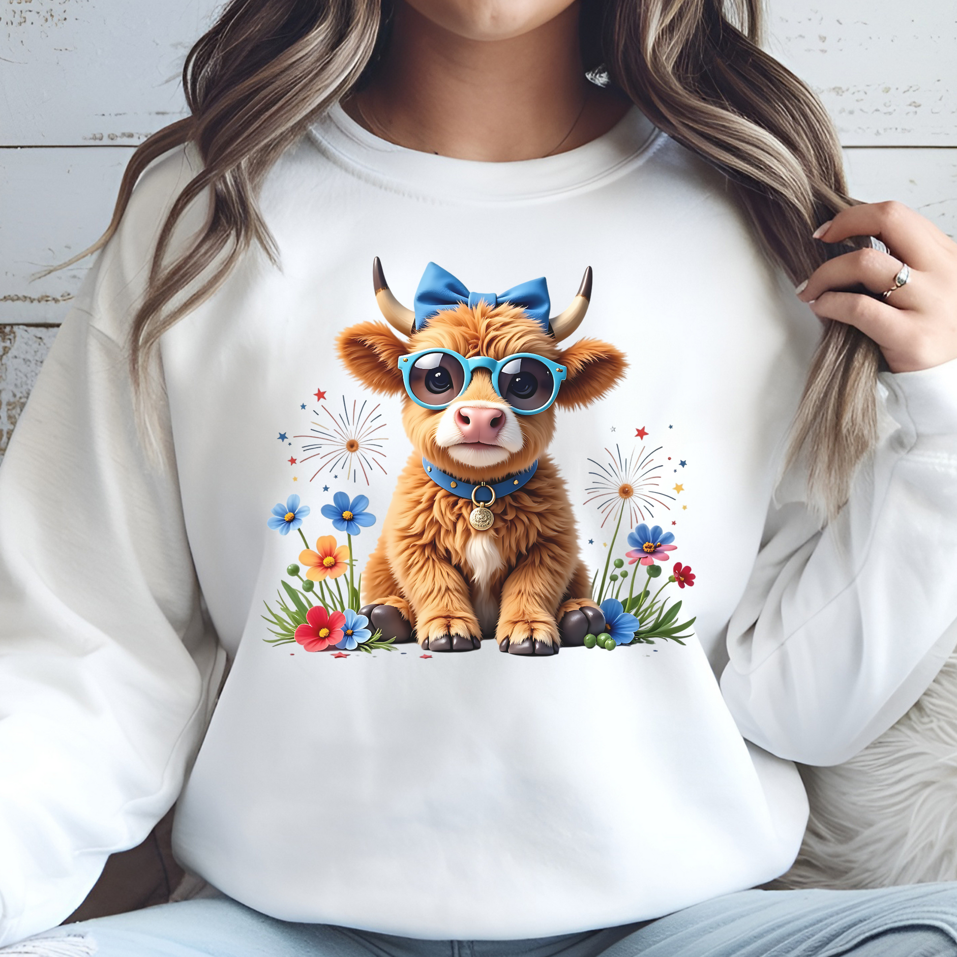 Highland Cow Patriotic 4th Of July digital design on a woman's sweatshirt