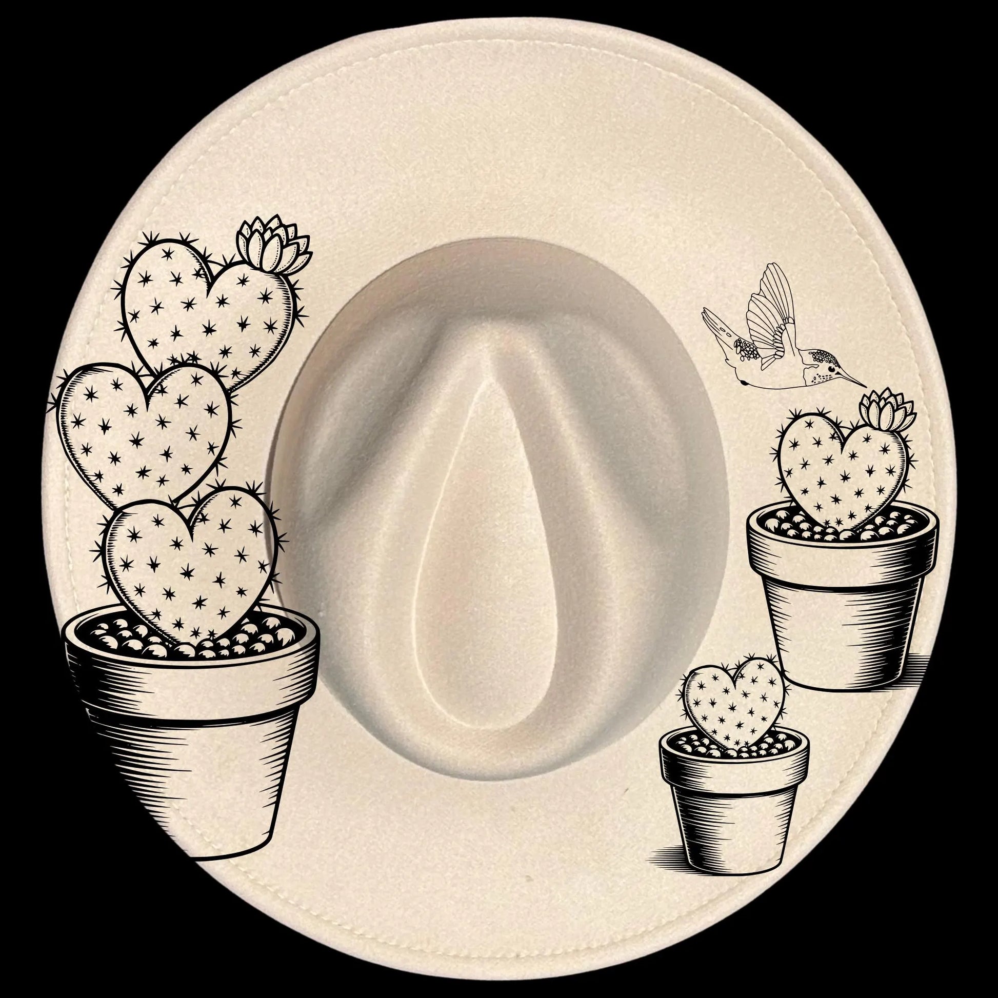 Wide brim hat with heart-shaped cacti and a hummingbird hat burning design on a black background