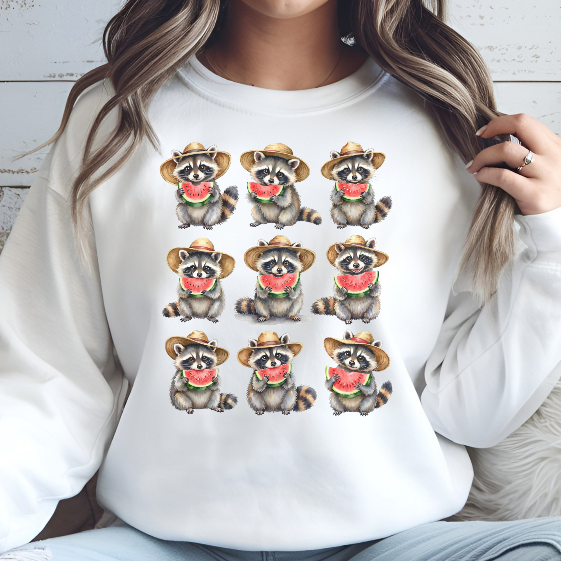Raccoons Eating Watermelon PNG digital design on a woman's white sweatshirt