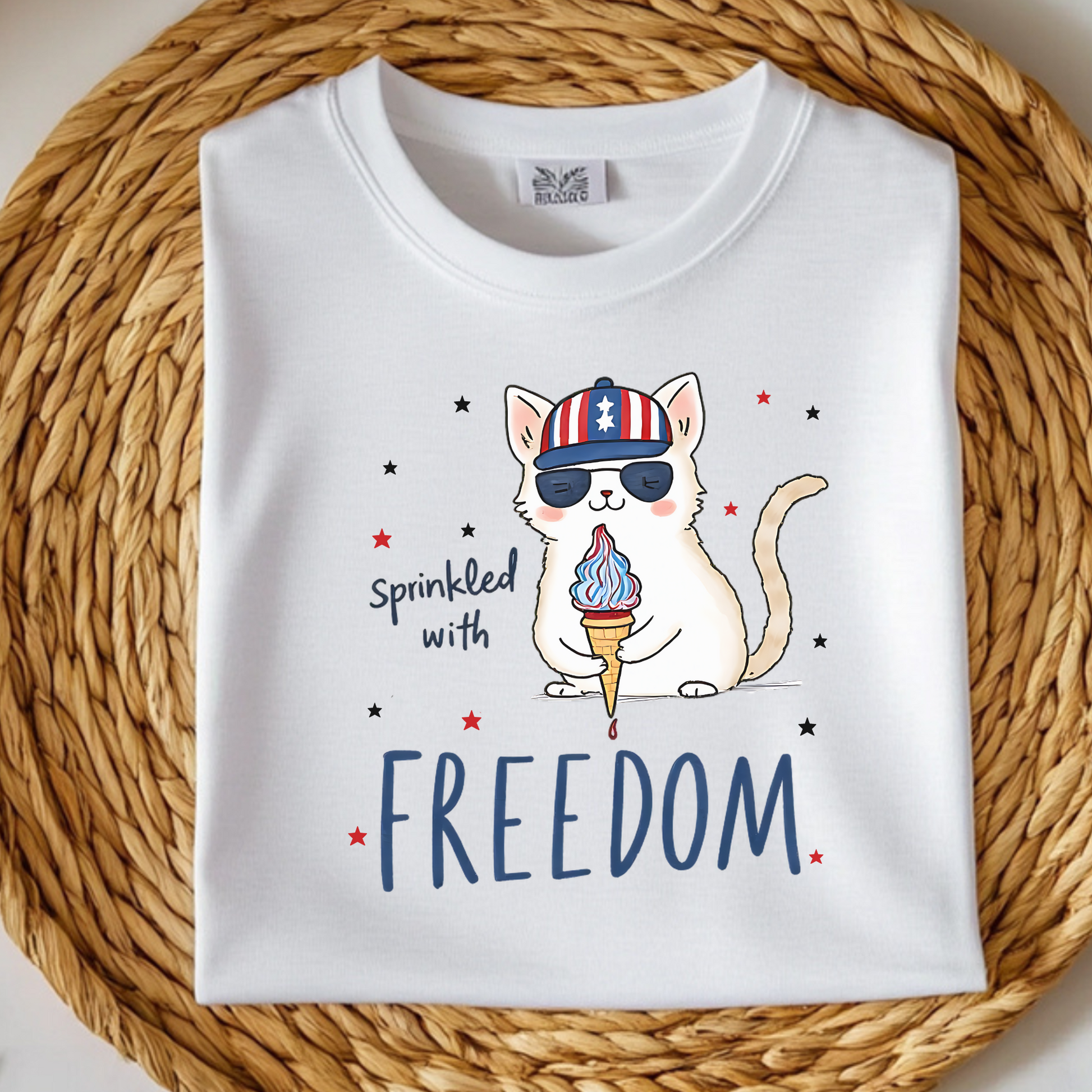 Sprinkled With Freedom Cat digital design on a folded t-shirt