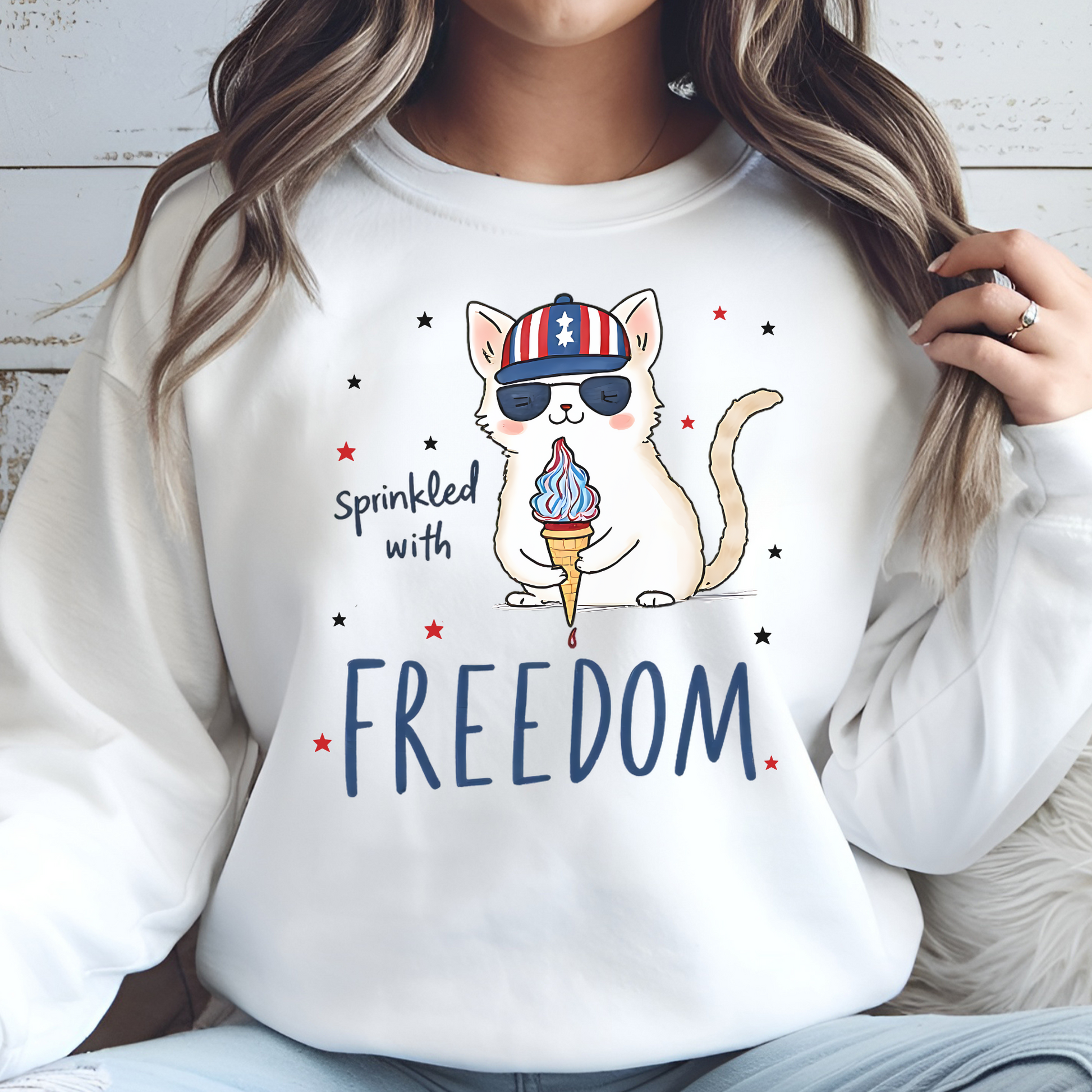 Sprinkled With Freedom Cat digital design on a woman's white sweat shirt