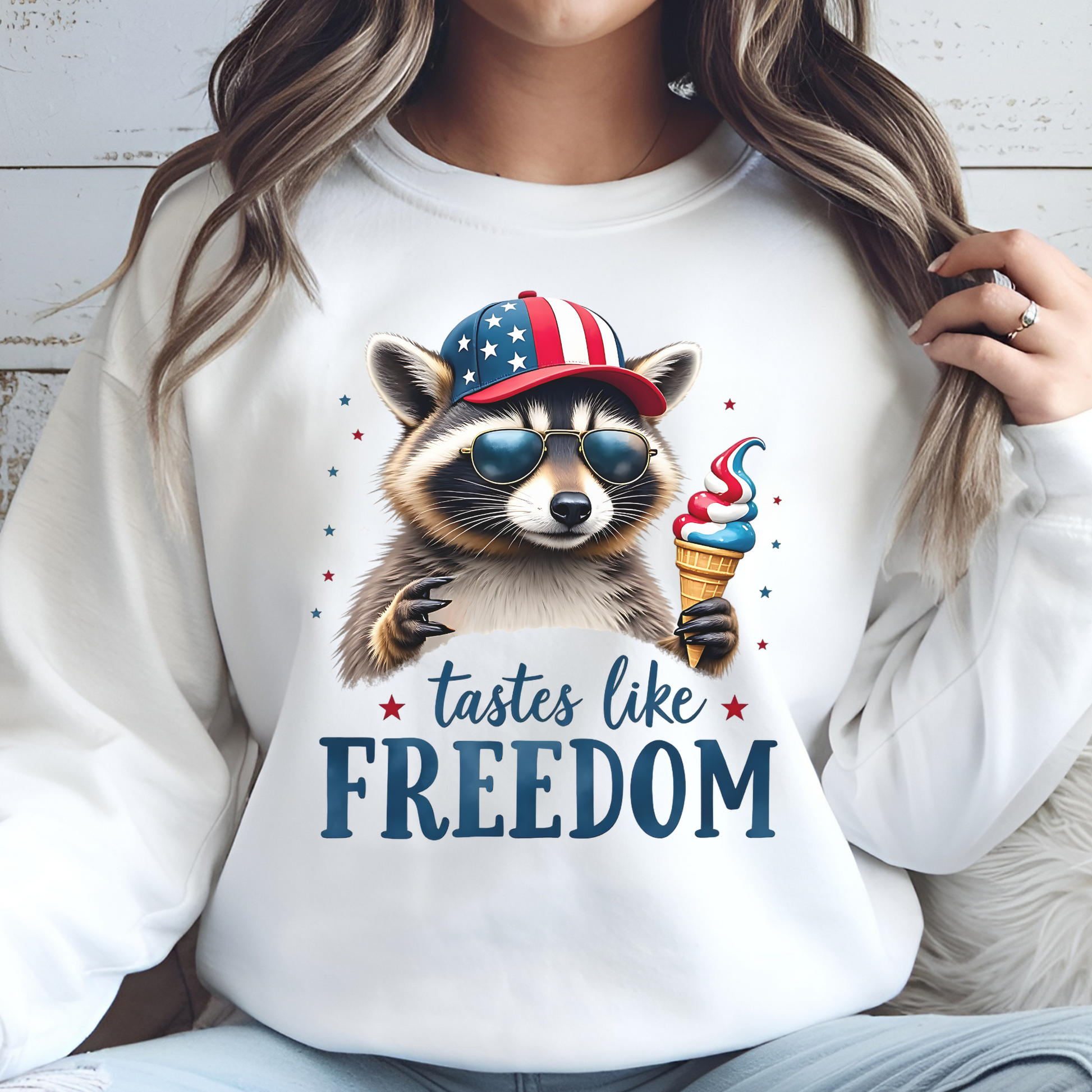 Patriotic Raccoon with Ice Cream and Hat, American Flag, Cool Sunglasses, T-Shirt Design, Independence Day Decor, Fun Animal Graphic on a white sweatshirt