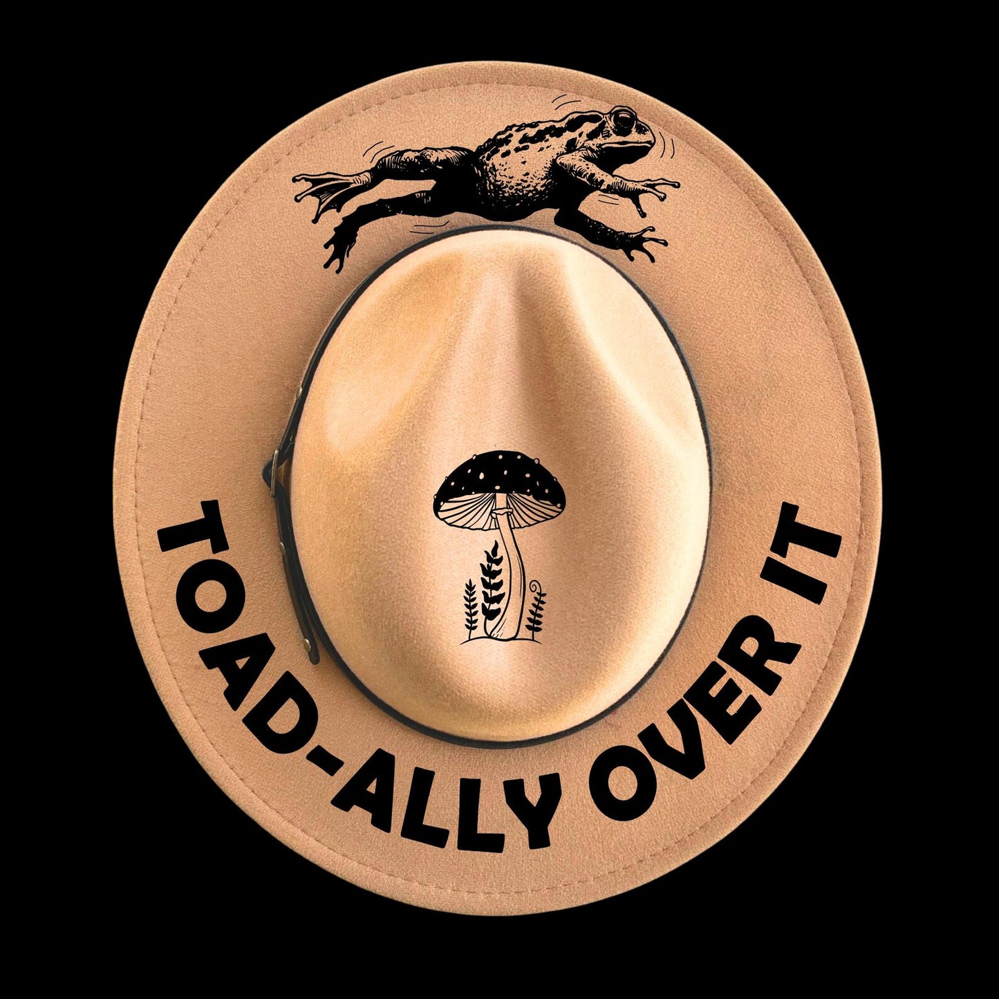 Beige hat with a frog and mushroom design, and text 'TOAD-ALLY OVER IT' on a black background.