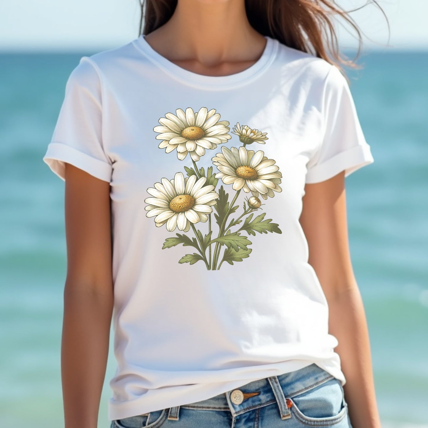 Woman wearing a white t-shirt with a floral design by the ocean.