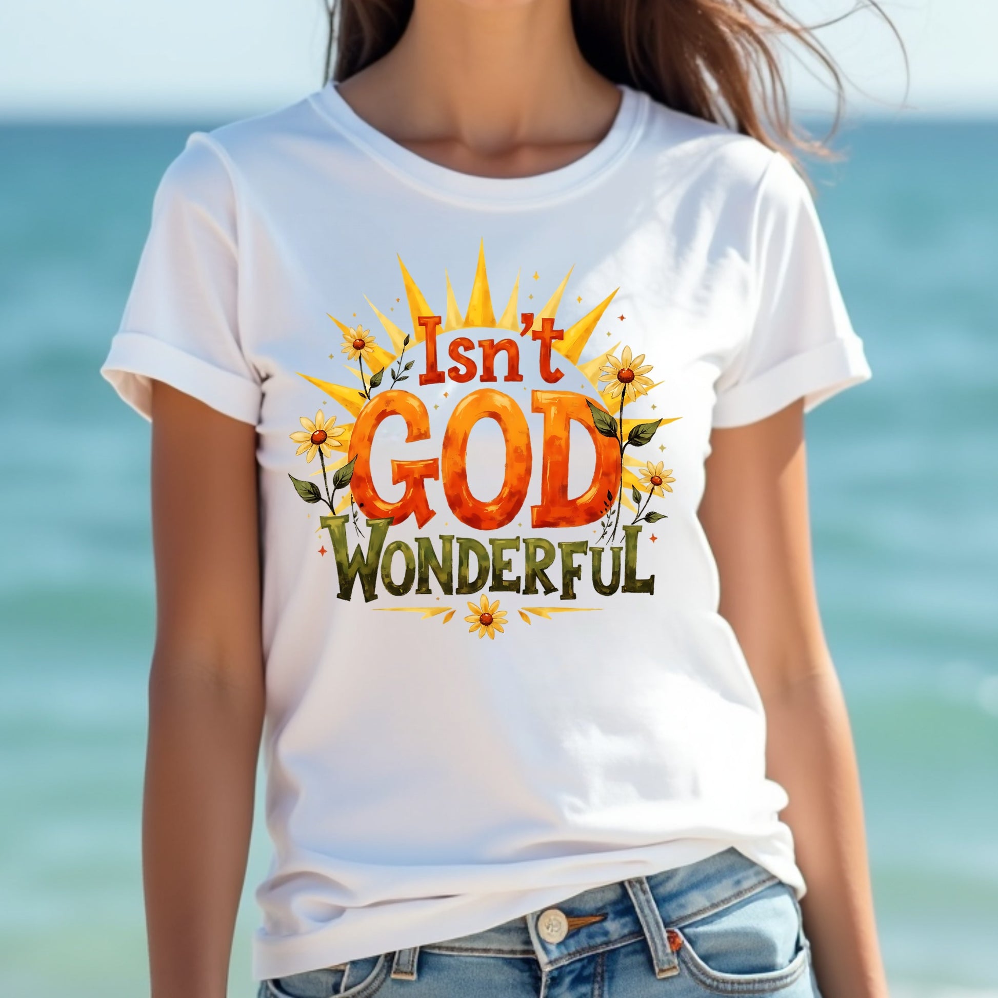 Woman wearing a white t-shirt with 'Isn't God Wonderful' design by the ocean.