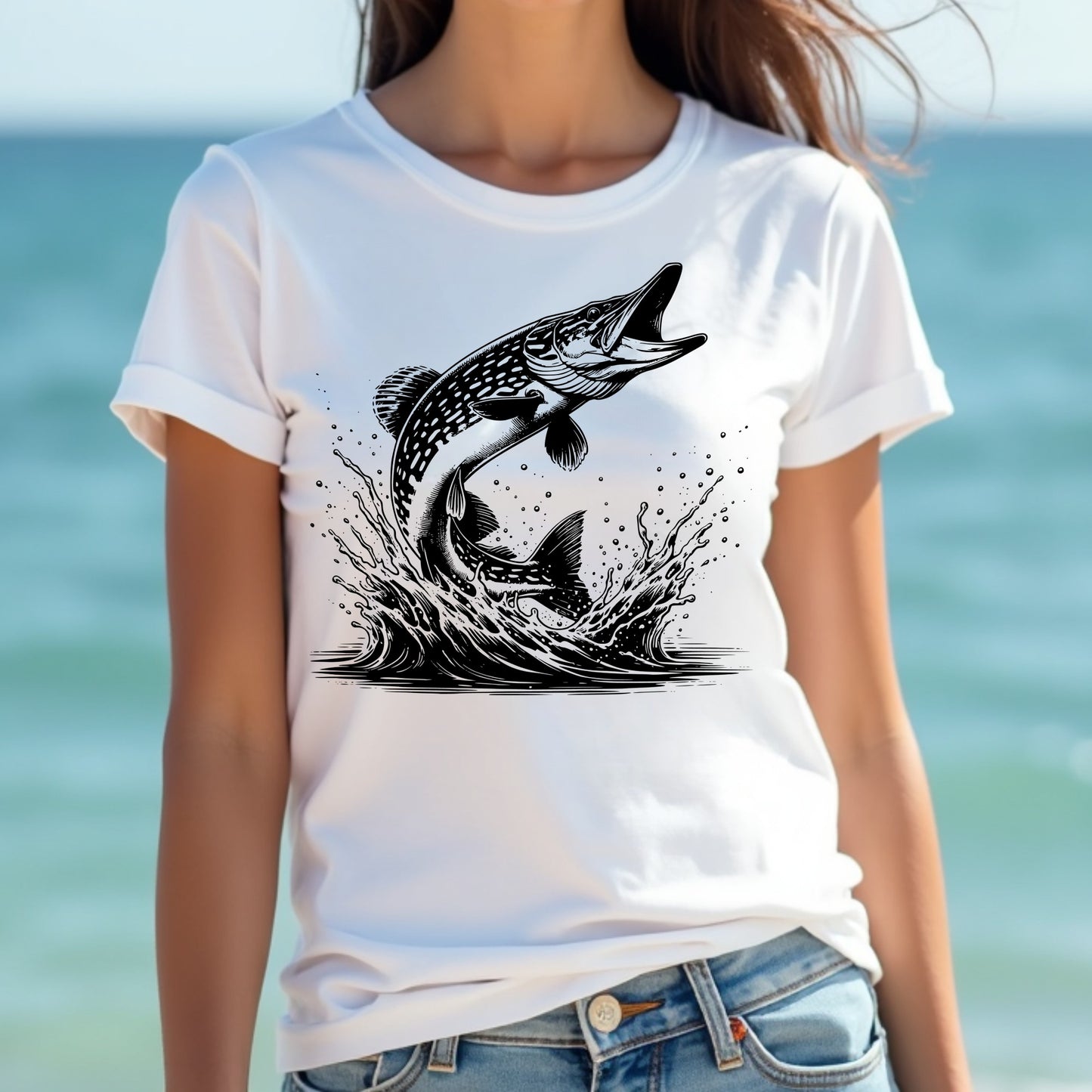 Woman wearing a white t-shirt with a pike fish graphic design against a blurred beach background