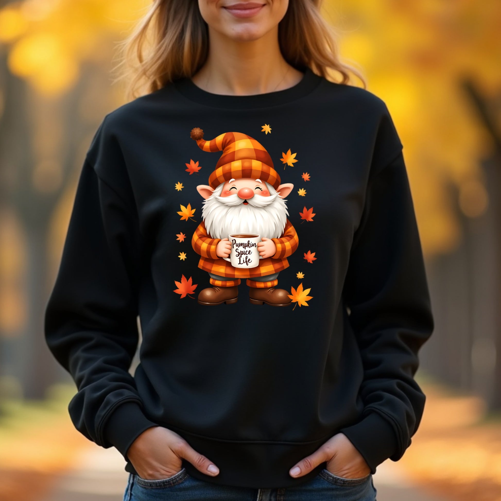 Woman wearing a black sweatshirt with a gnome graphic and 'Pumpkin Spice Life' text, standing in an autumn setting.