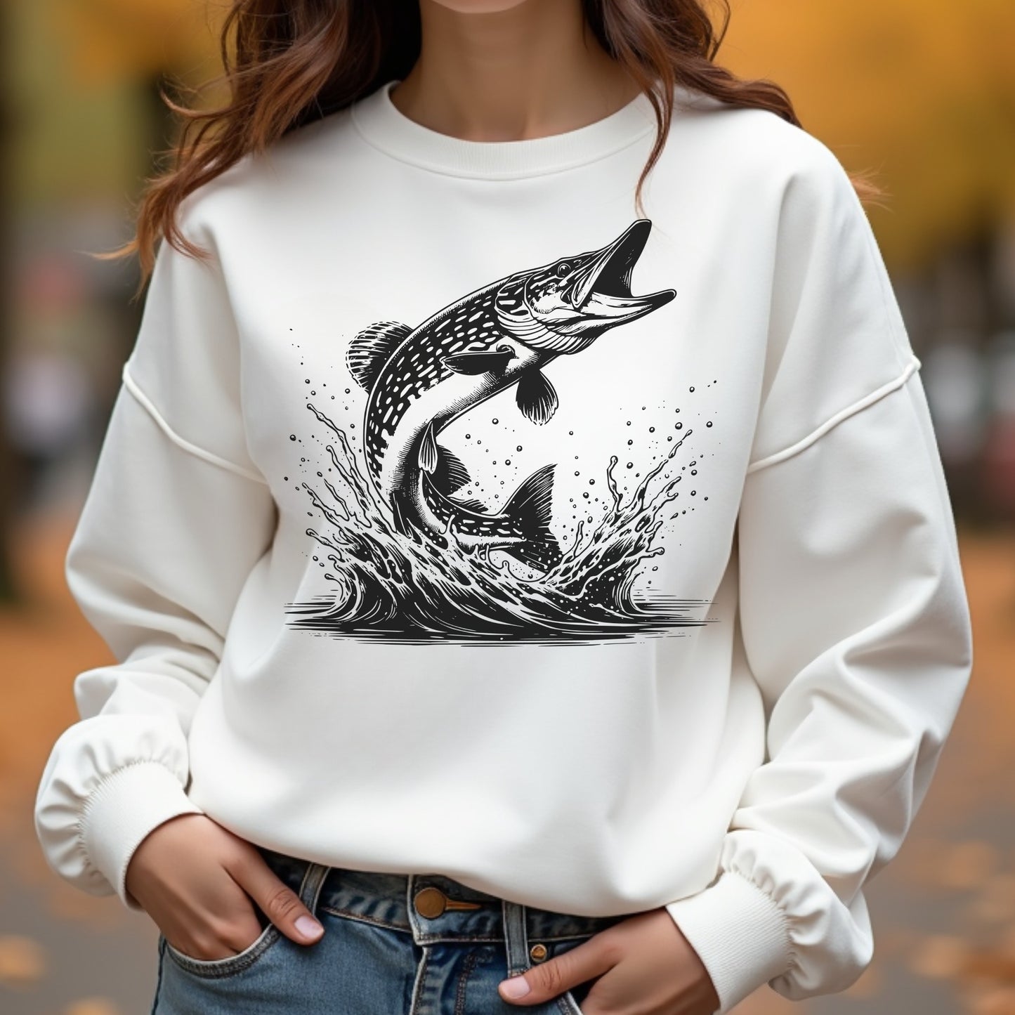 White sweatshirt with black fish silhouette graphic worn by a woman outdoors