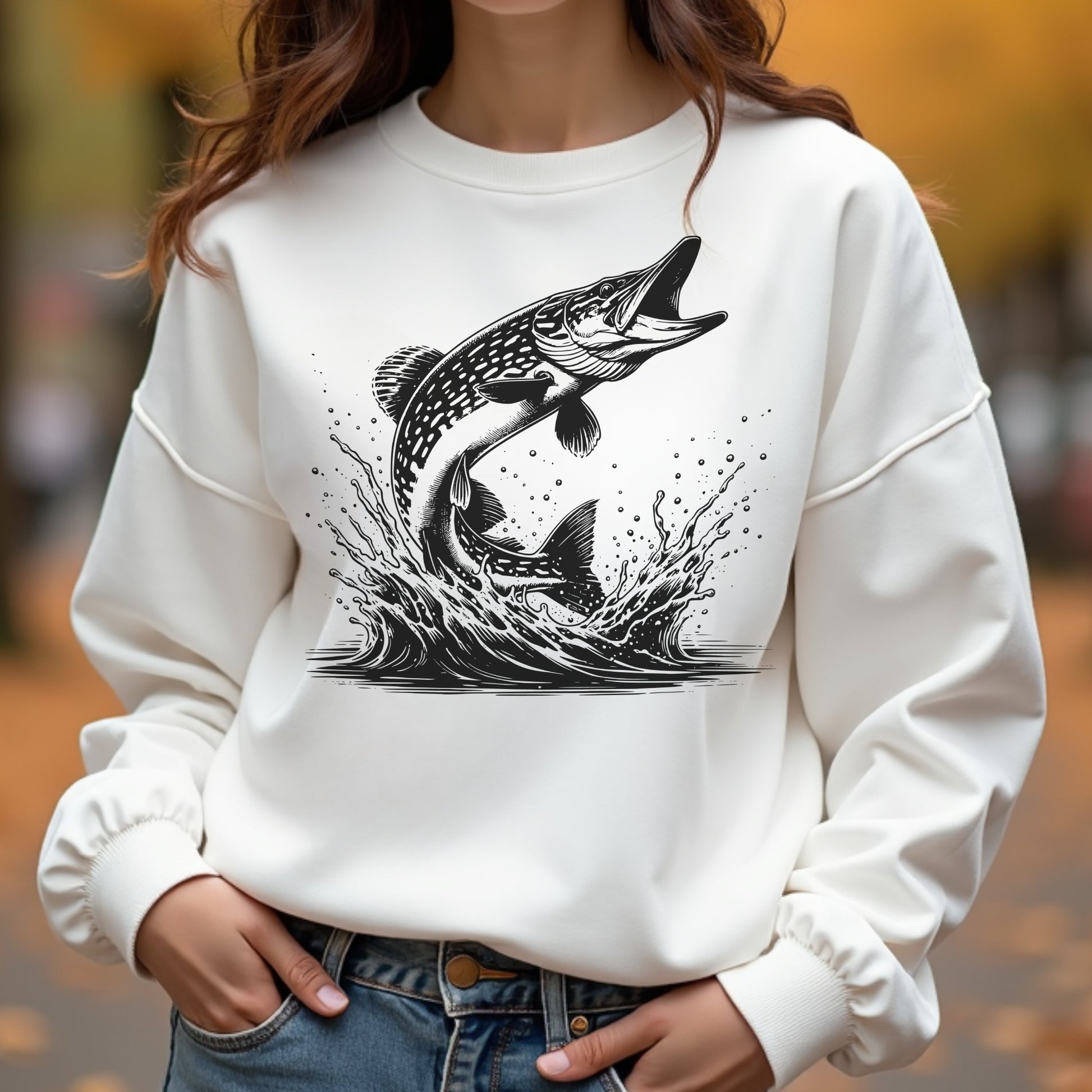 White sweatshirt with black fish silhouette graphic worn by a woman outdoors