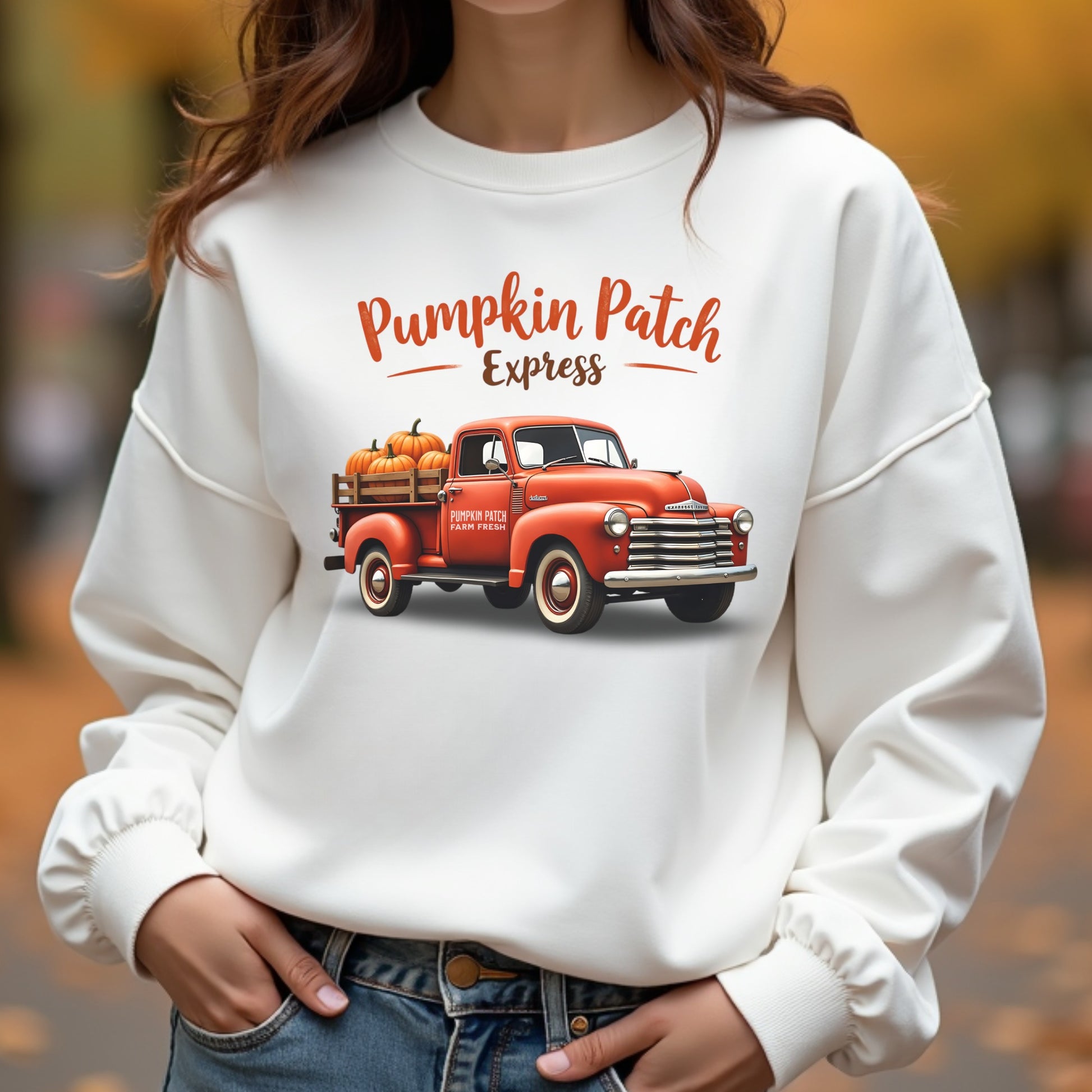 Woman wearing a pumpkin patch truck sweatshirt in an autumn forest