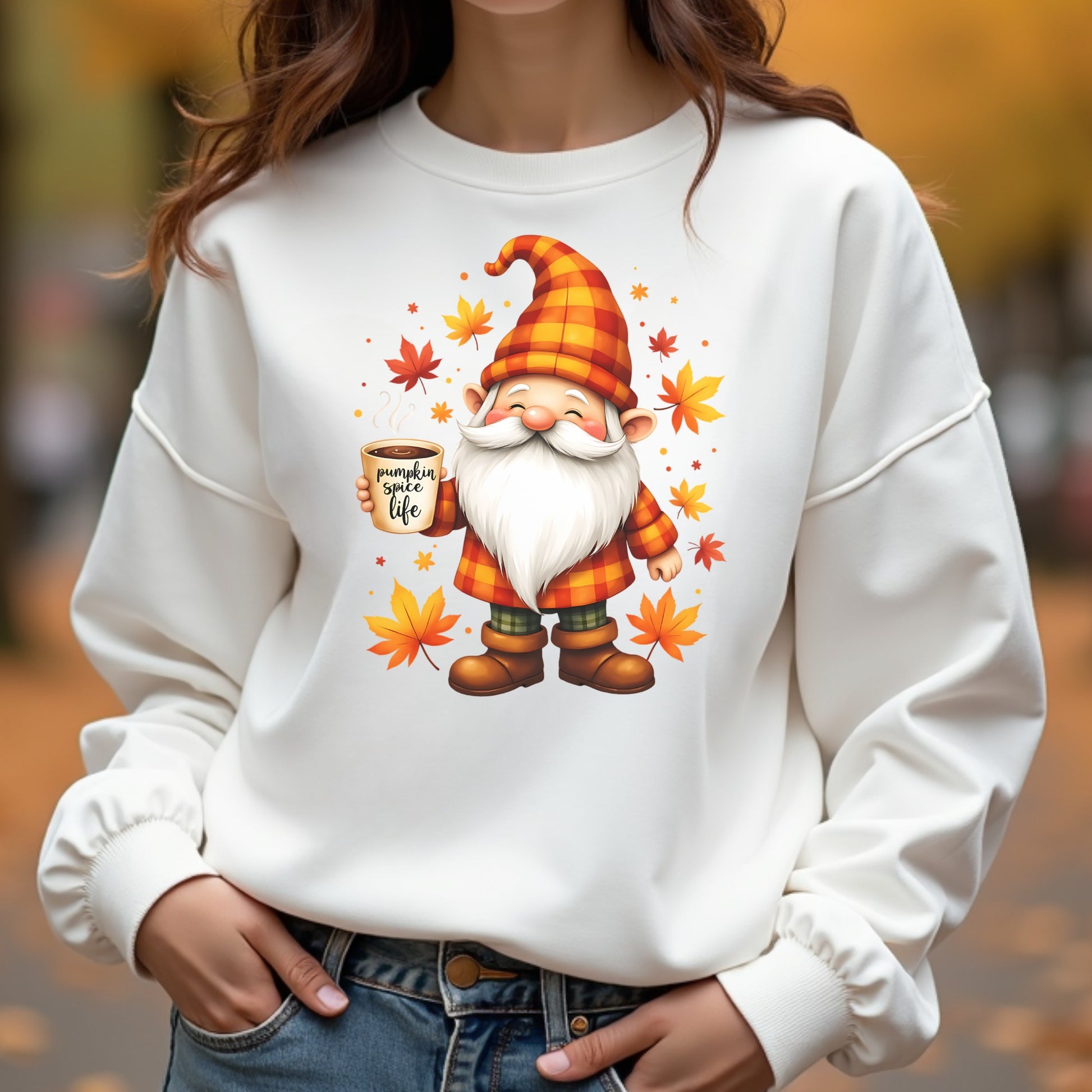 White sweatshirt with a cartoon gnome holding a pumpkin spice latte and autumn leaves.