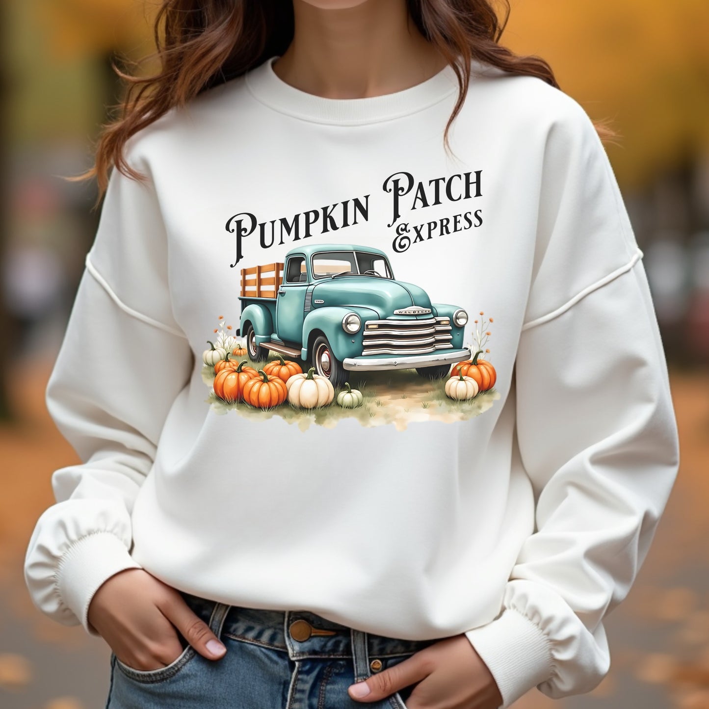 White sweatshirt with 'Pumpkin Patch Express' graphic featuring a vintage truck and pumpkins.