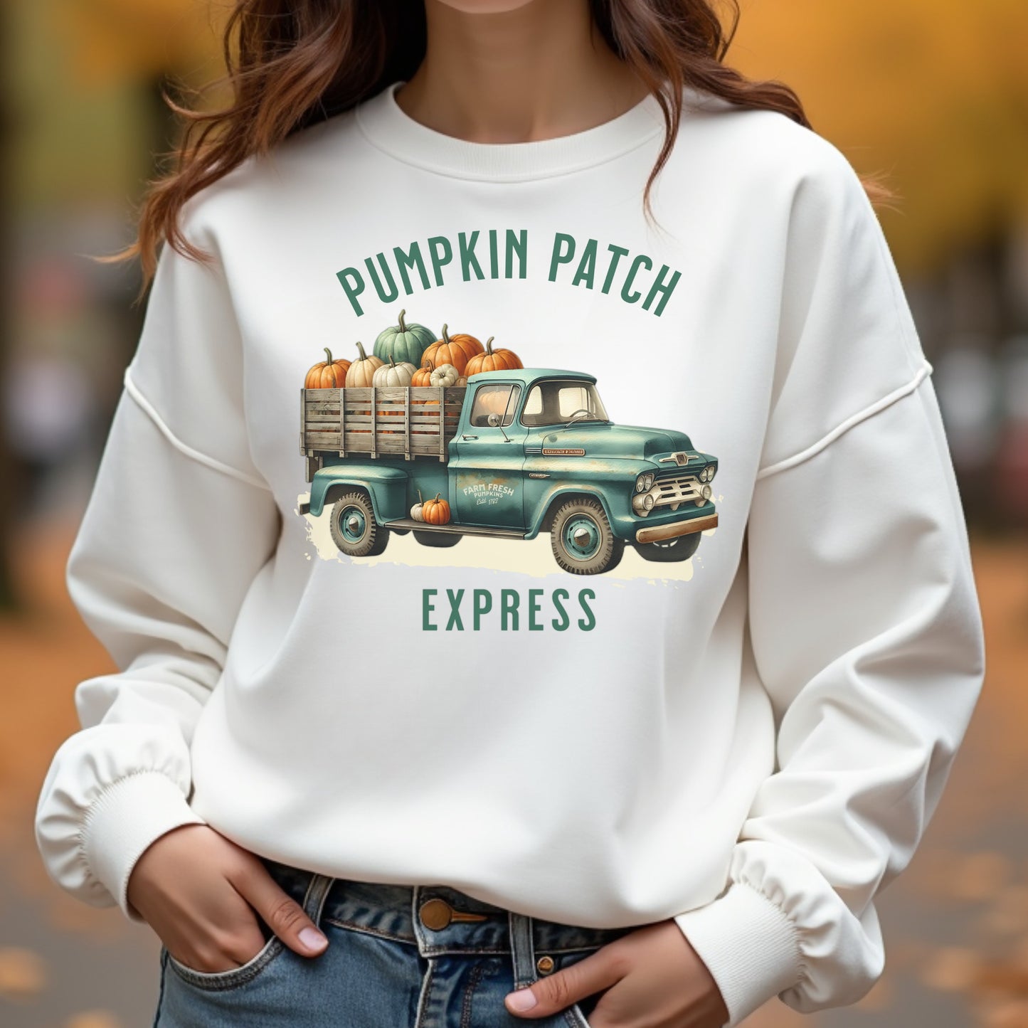 A woman wearing a pumpkin patch express sweatshirt in autumn
