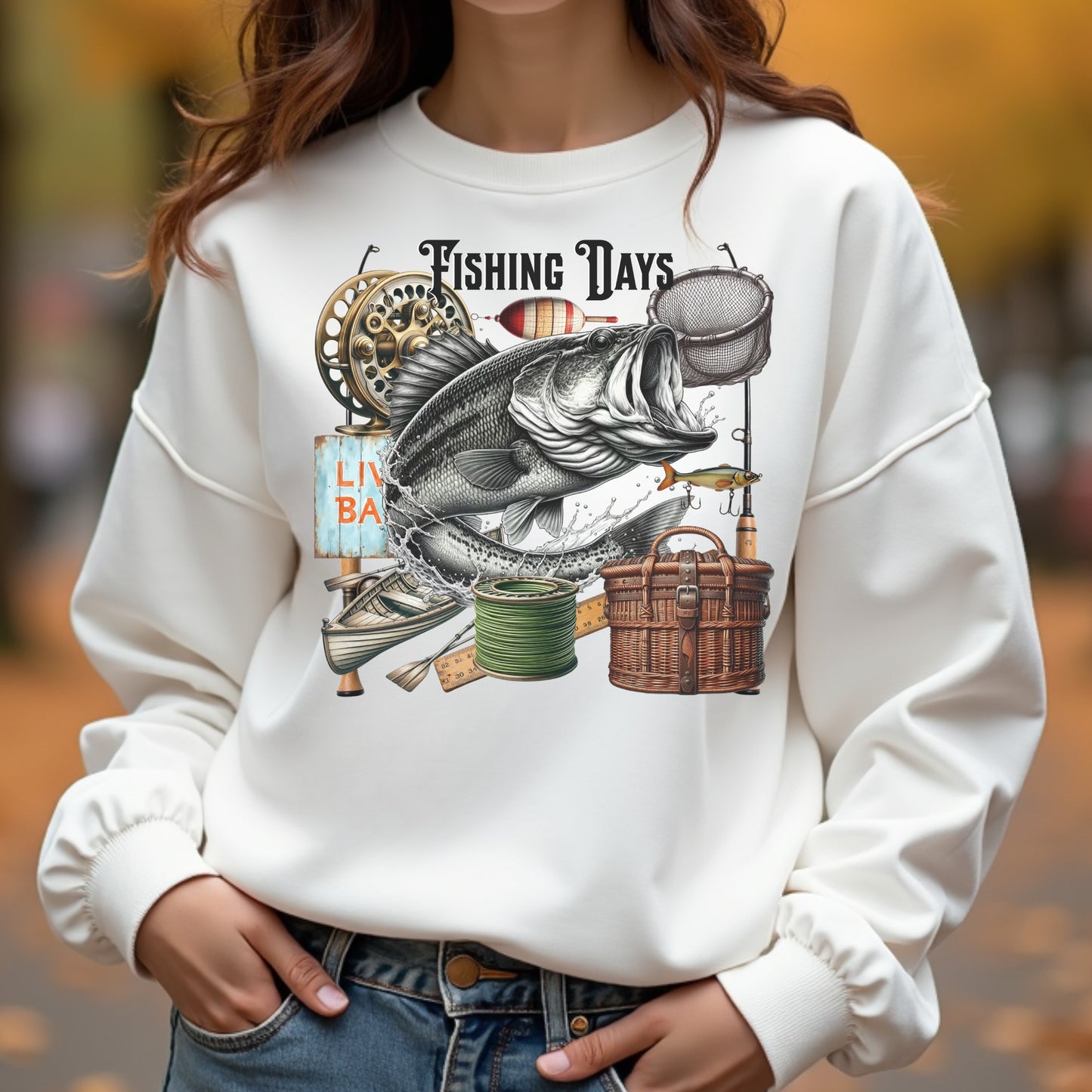 Woman wearing a white sweatshirt with a fishing-themed graphic design.