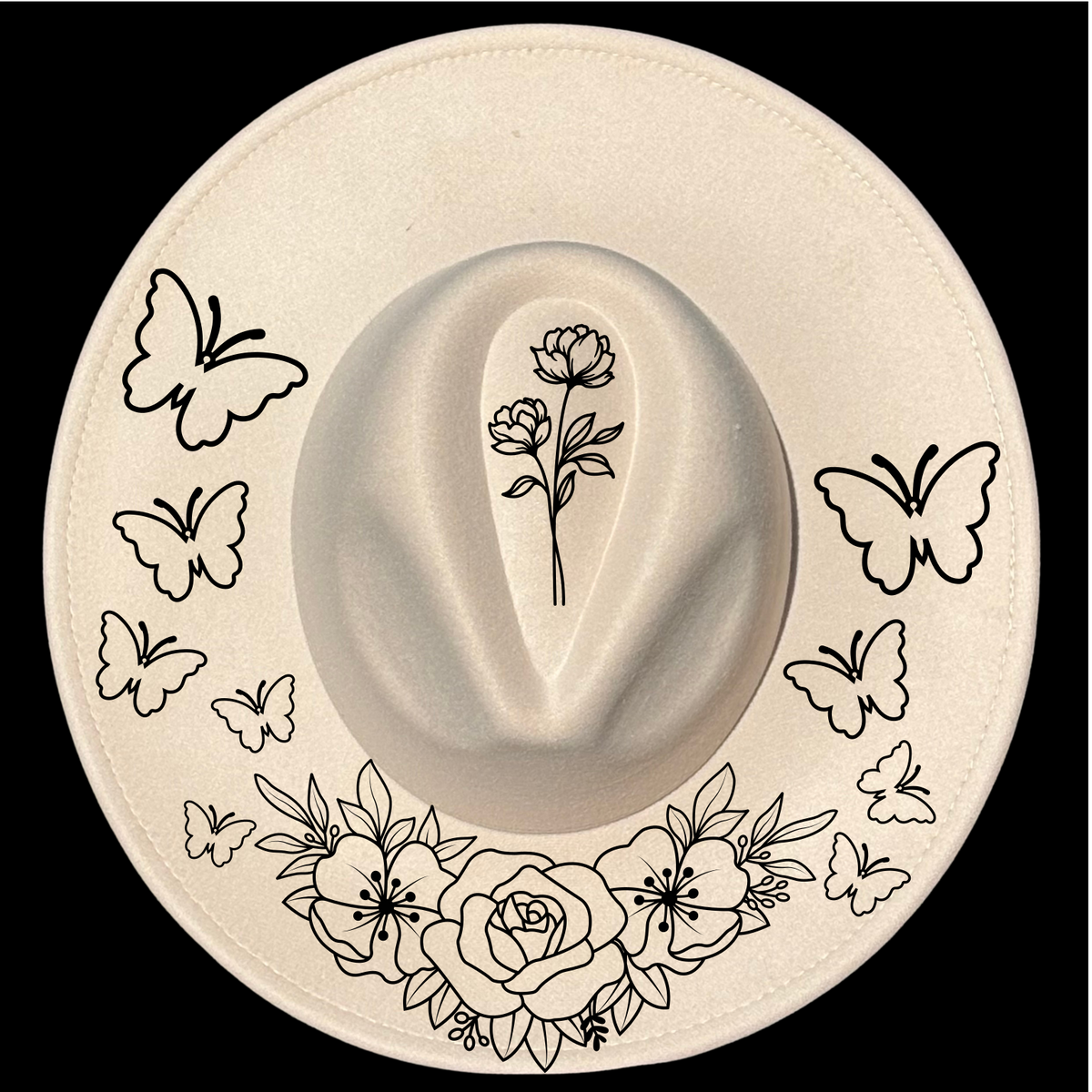 A beige wide brim hat with a floral and butterfly design, featuring a prominent butterfly on the side and small floral patterns around the brim.