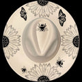 A white wide brim hat with a floral pattern featuring sunflowers and butterflies, and a bee motif at the top.