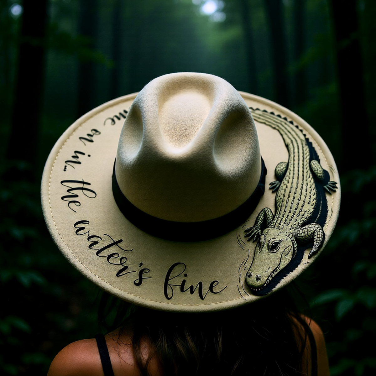 Beige hat with alligator design and text against a forest background