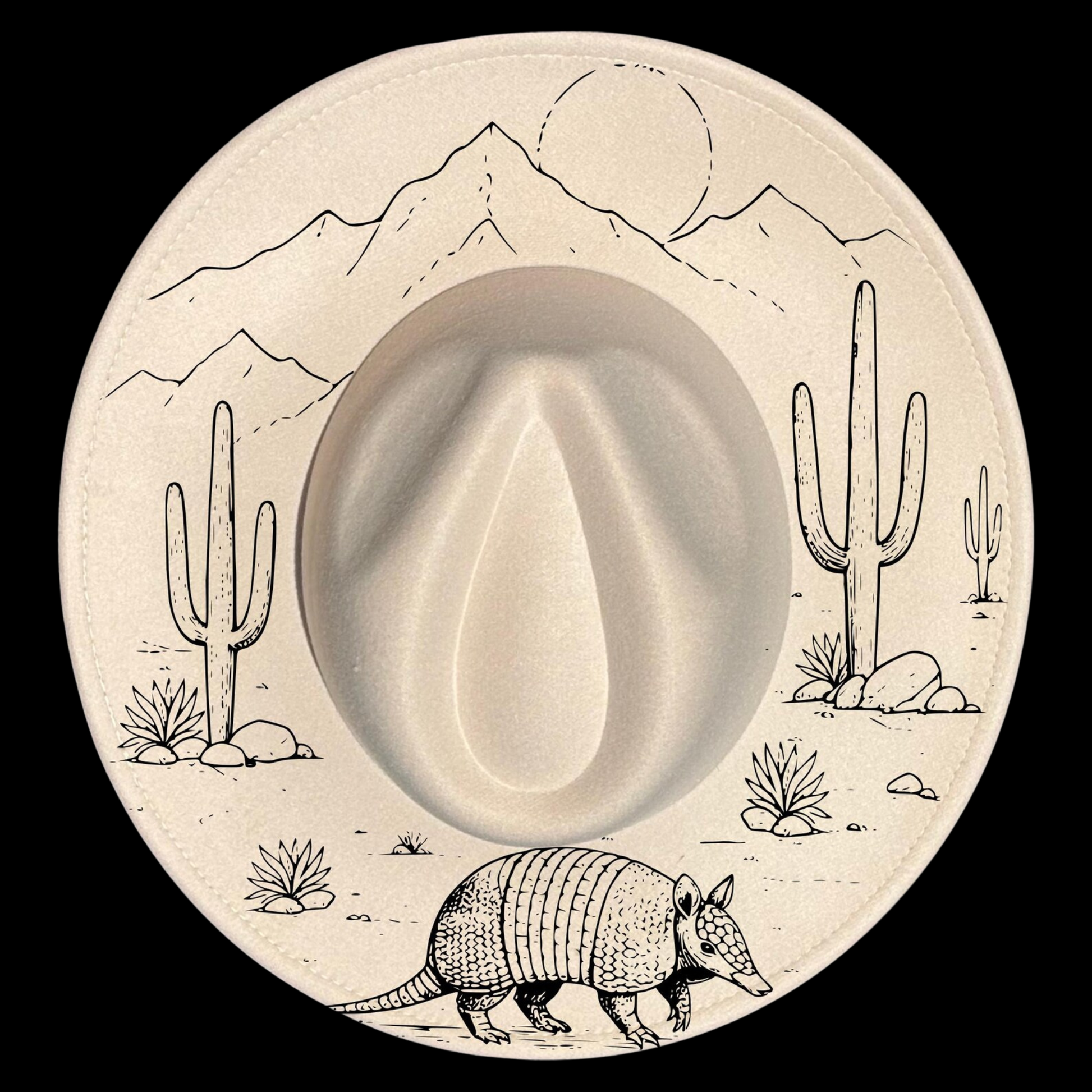 A wide brim hat with desert scene including cacti, mountains, and an armadillo.