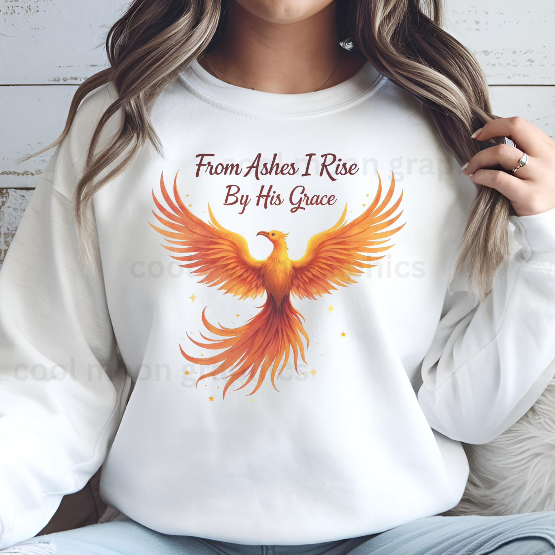 White sweatshirt with a phoenix design and text worn by a woman.