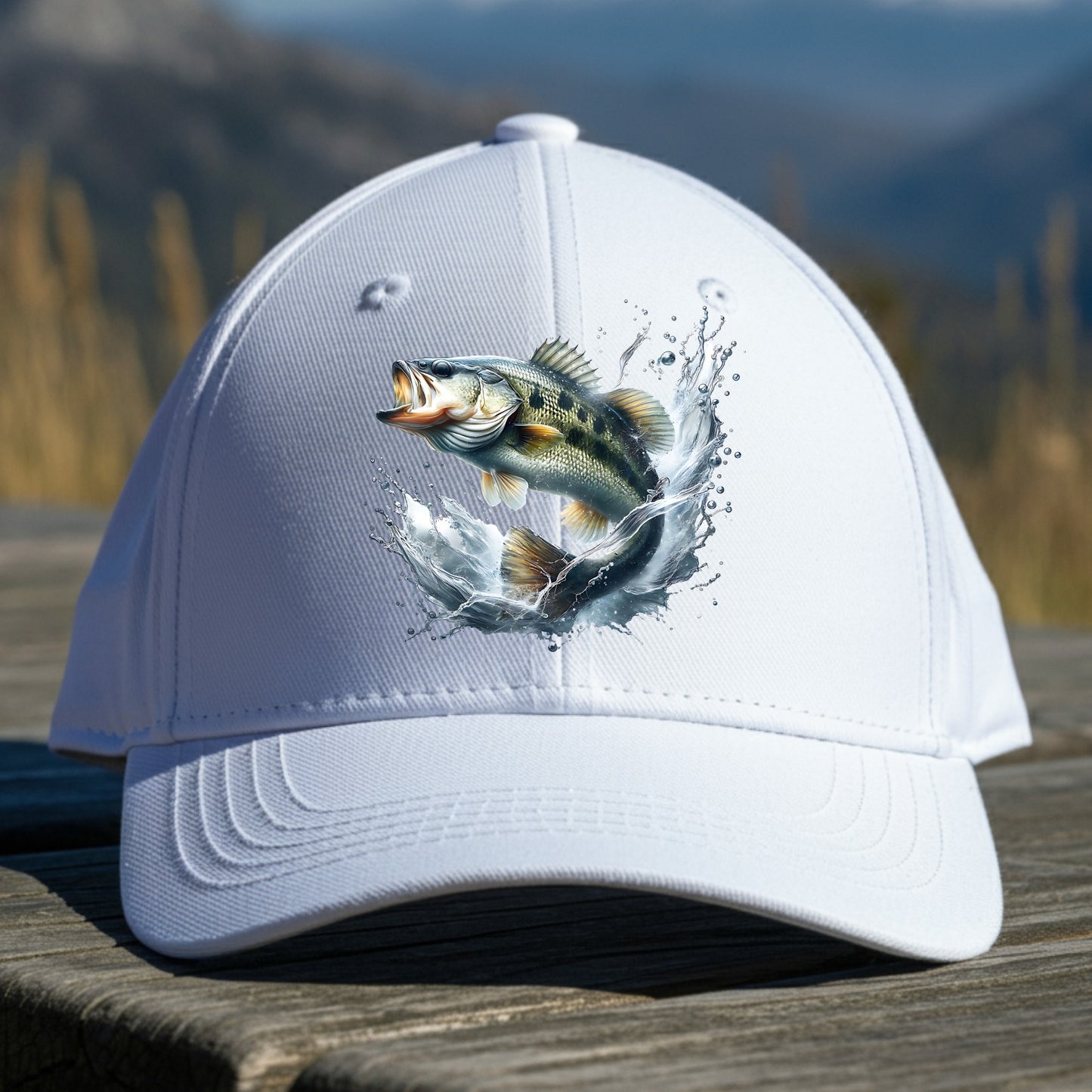 White cap with a smallmouth bass fish design on a wooden surface with a mountain background