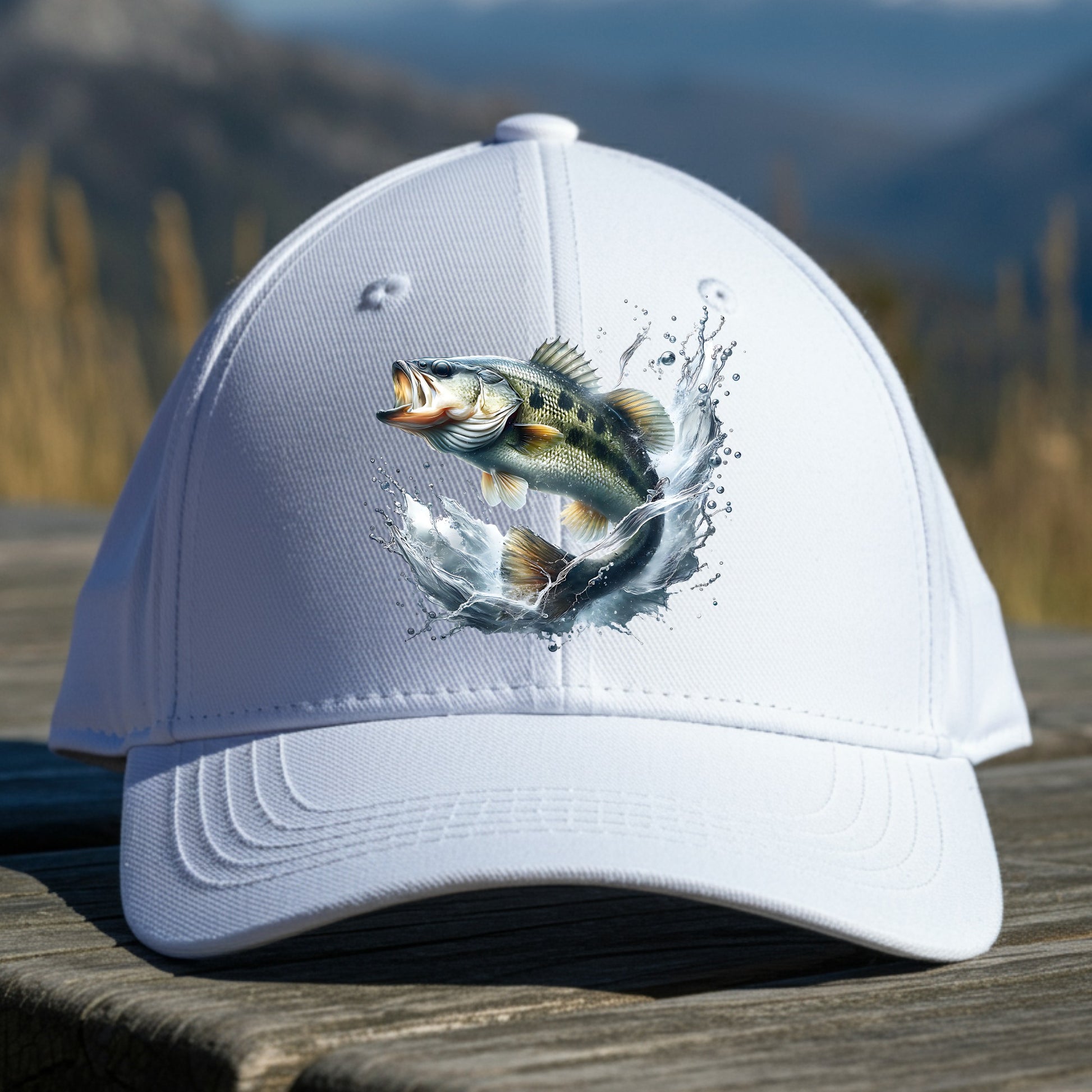 White cap with a smallmouth bass fish design on a wooden surface with a mountain background