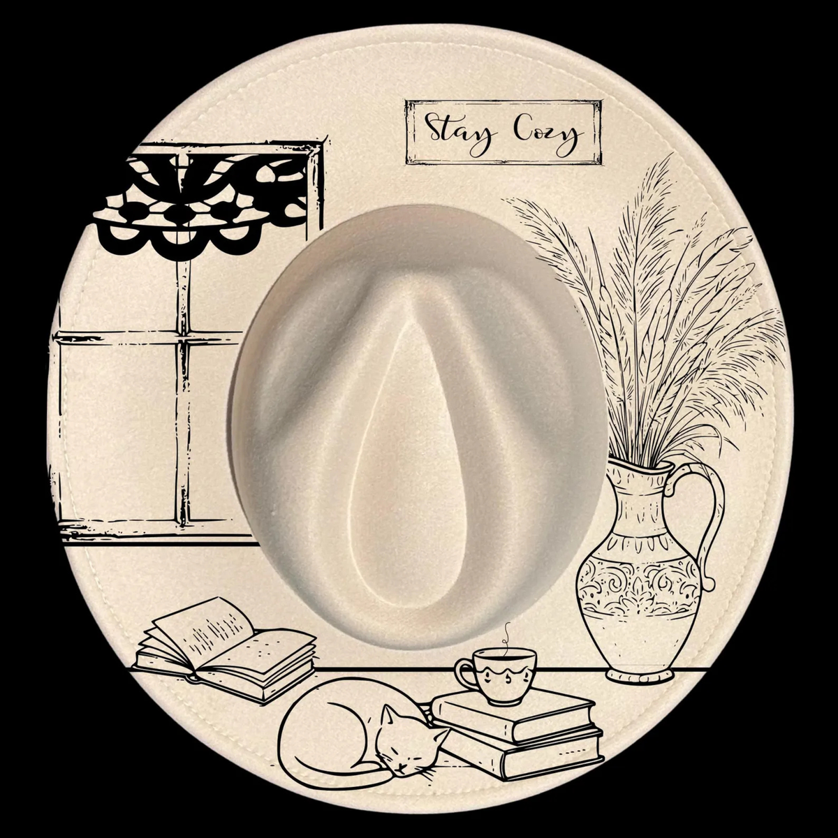 Decorative wide brim hat with a teacup, books, cat, and plant illustration with 'Stay Cozy' text.