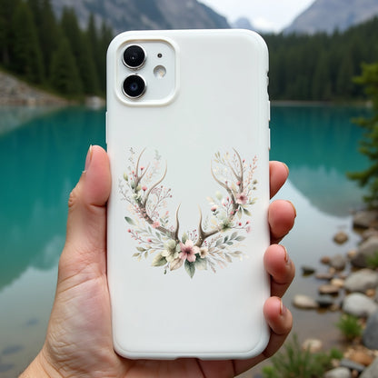 Phone case with floral design held in front of a scenic lake and mountains