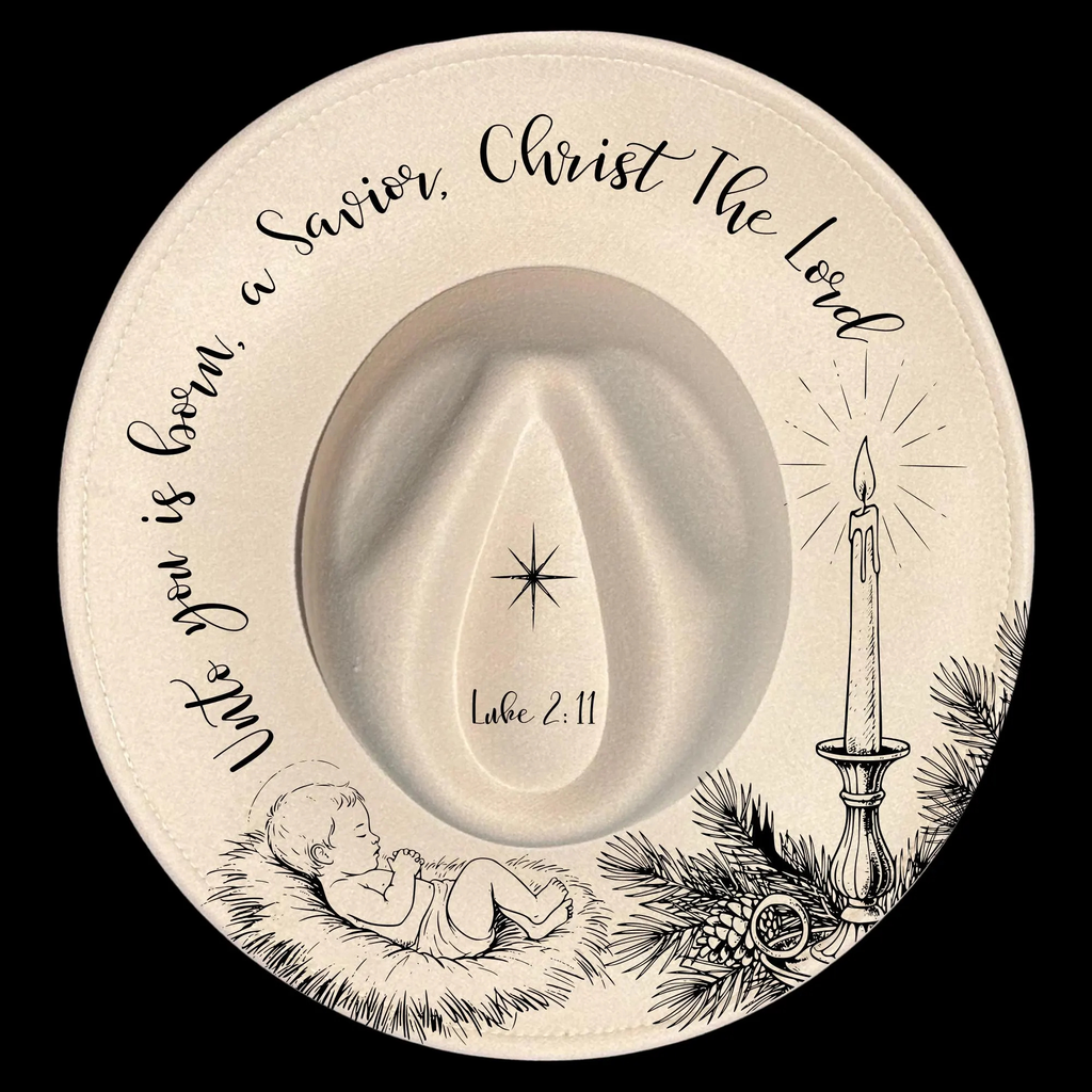 Decorative hat with baby Jesus, candle, and text on a black background