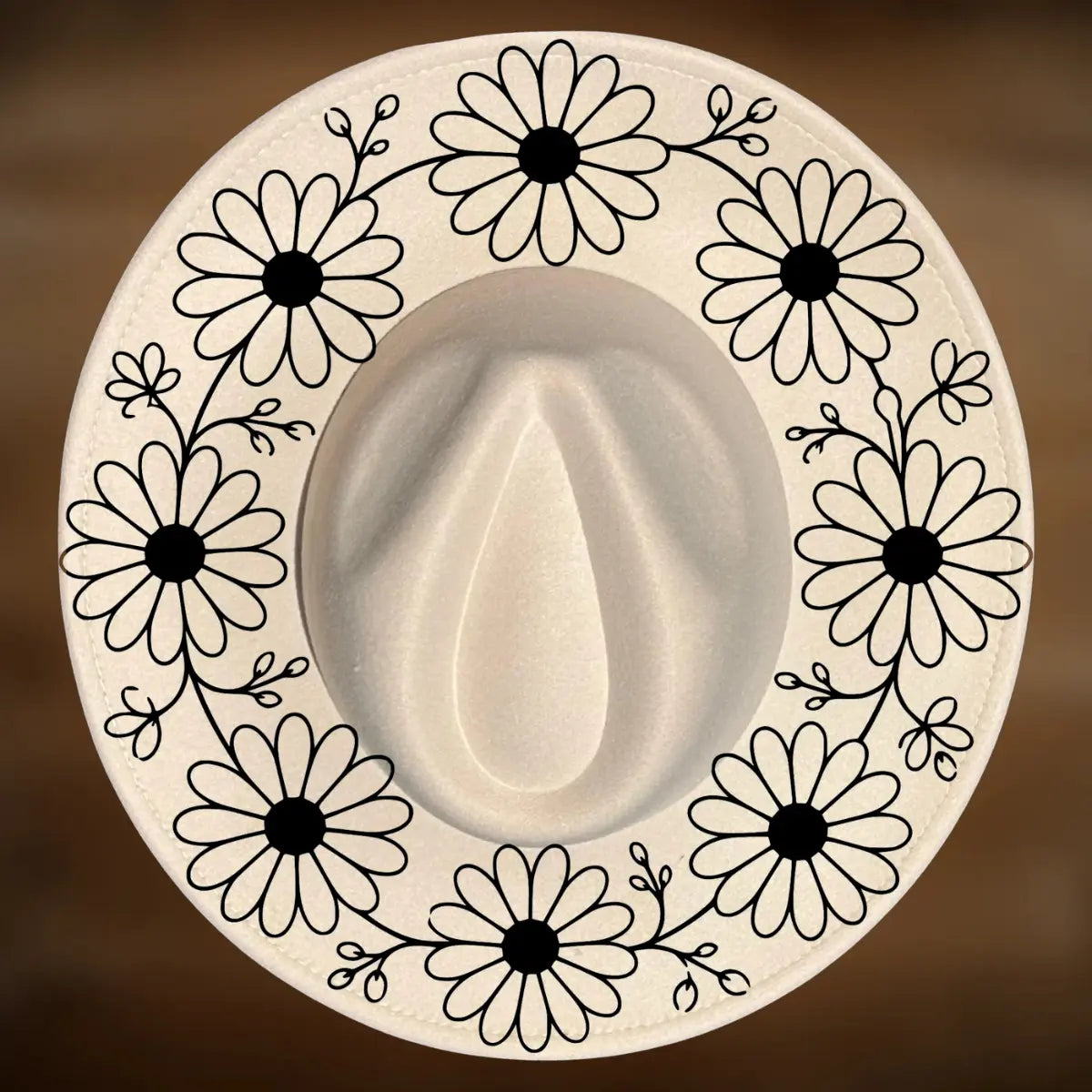 A circle of daisy designs on a wide brim hat.