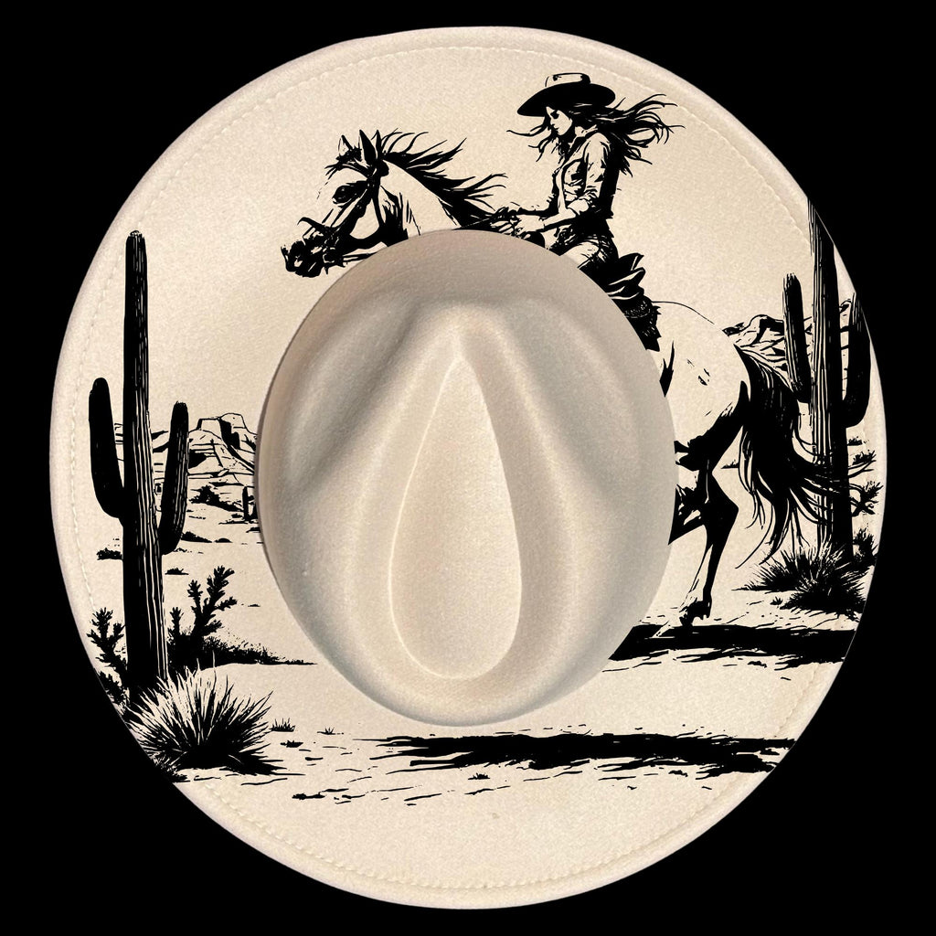 Hat with a cowboy and horse design on a desert landscape.