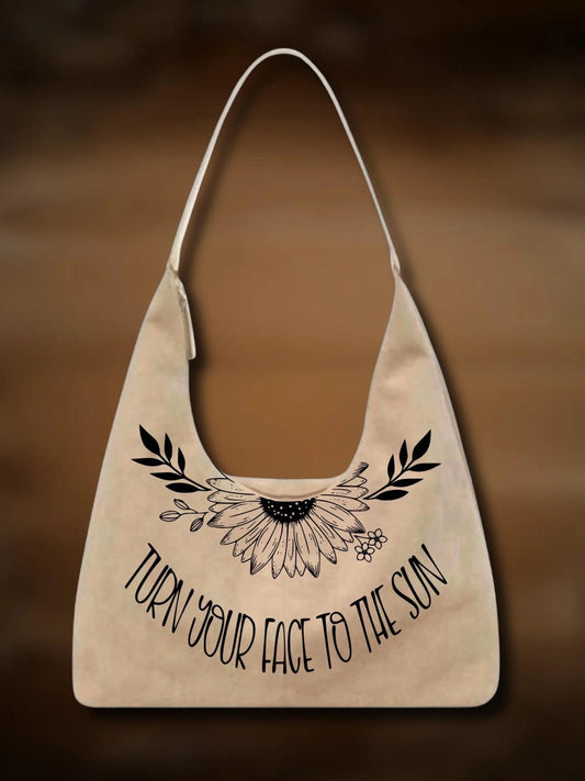 Beige tote bag with floral design and text on a brown background