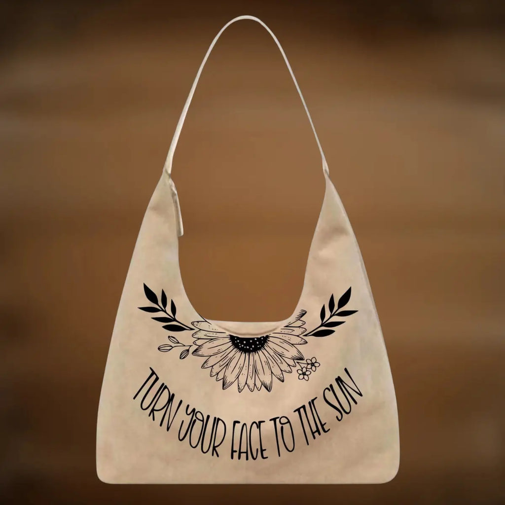 Beige tote bag with black floral design and text on a brown background