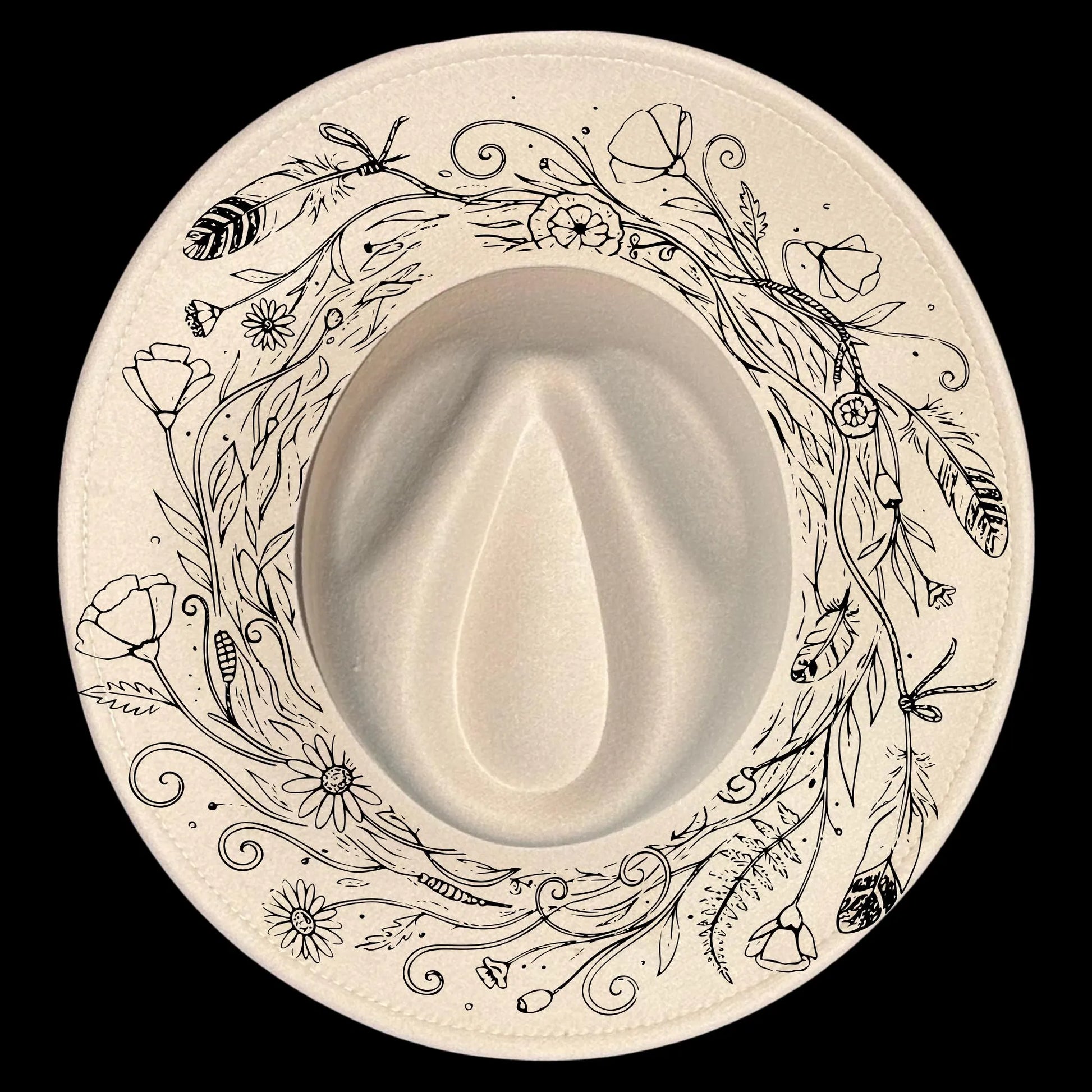 Wide brim hat with floral and leaf patterns on a black background