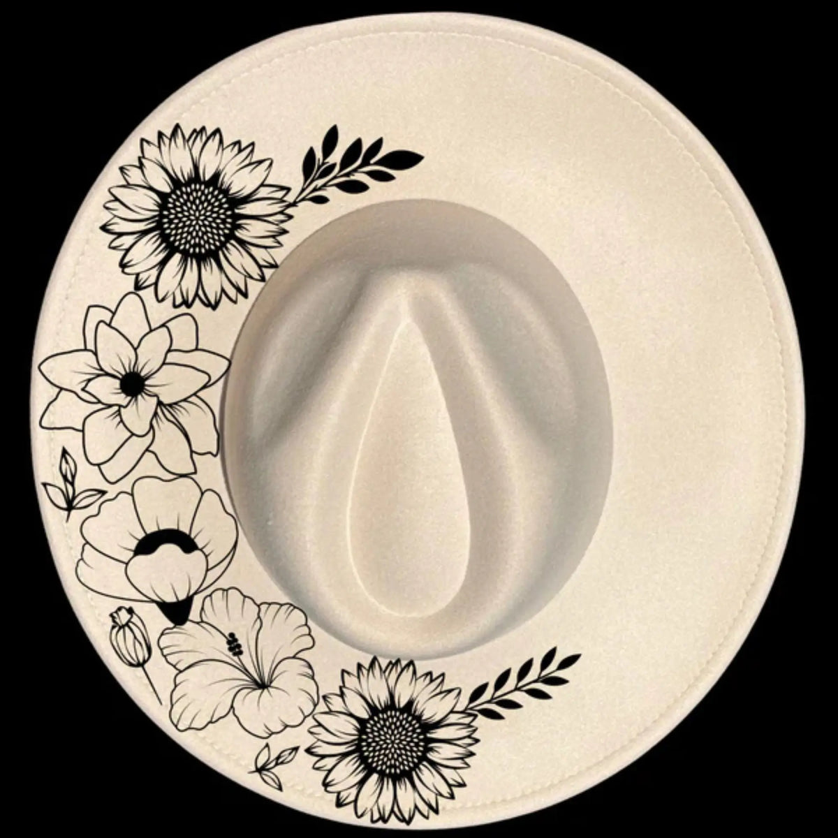 White cowboy hat with black floral designs on a black background 050226