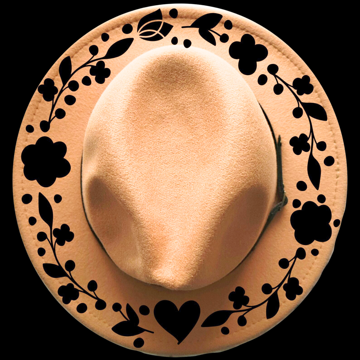 Beige hat with decorative black patterns on a black background