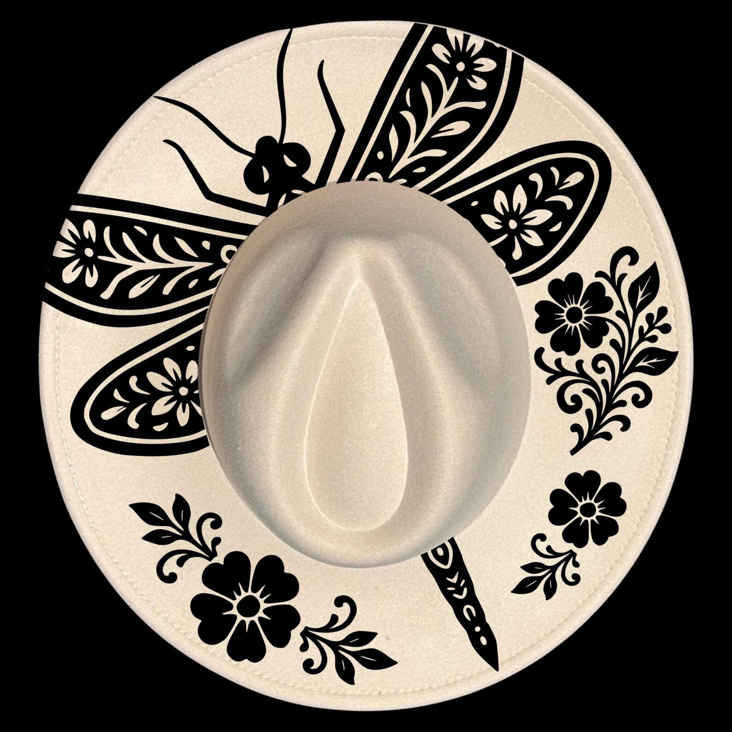 White cowboy hat with black floral and leaf patterns on a white background