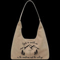 Purse with mountain and cross design and text on a black background