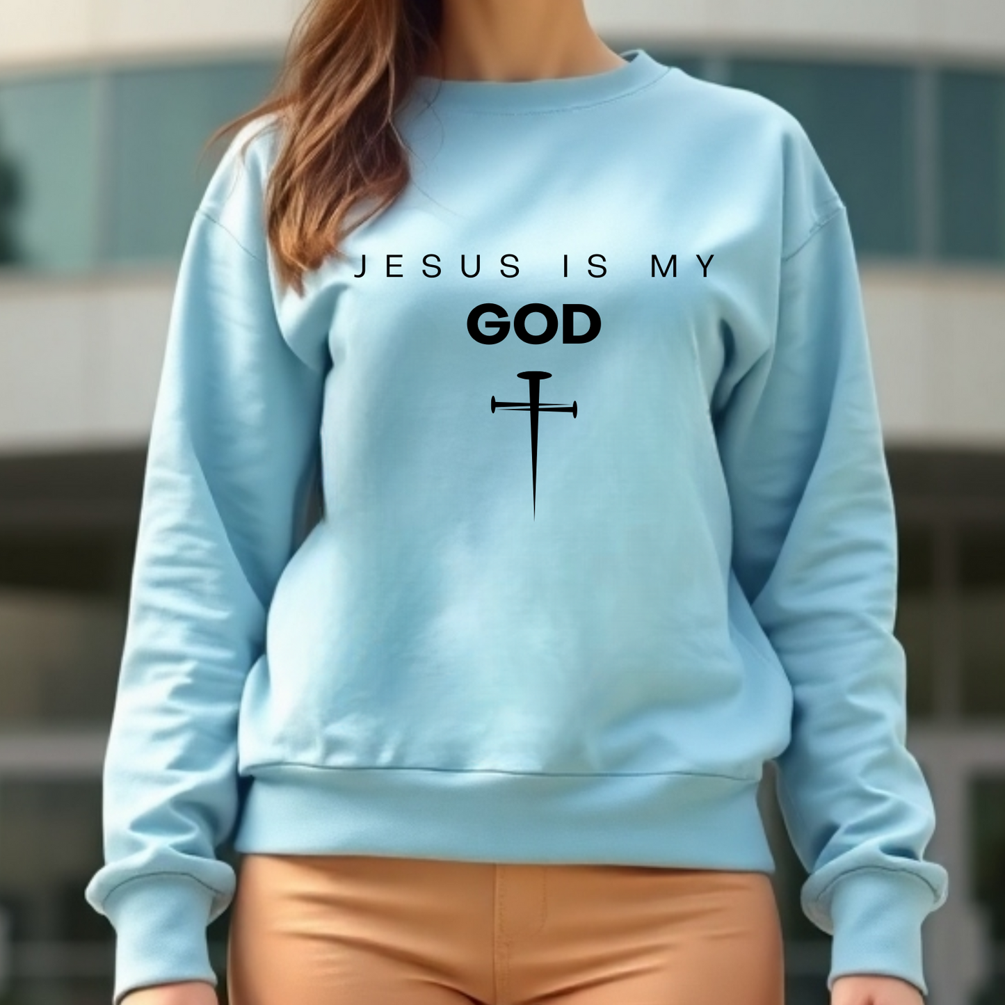 Jesus Is My God digital design on a woman’s blue sweatshirt.