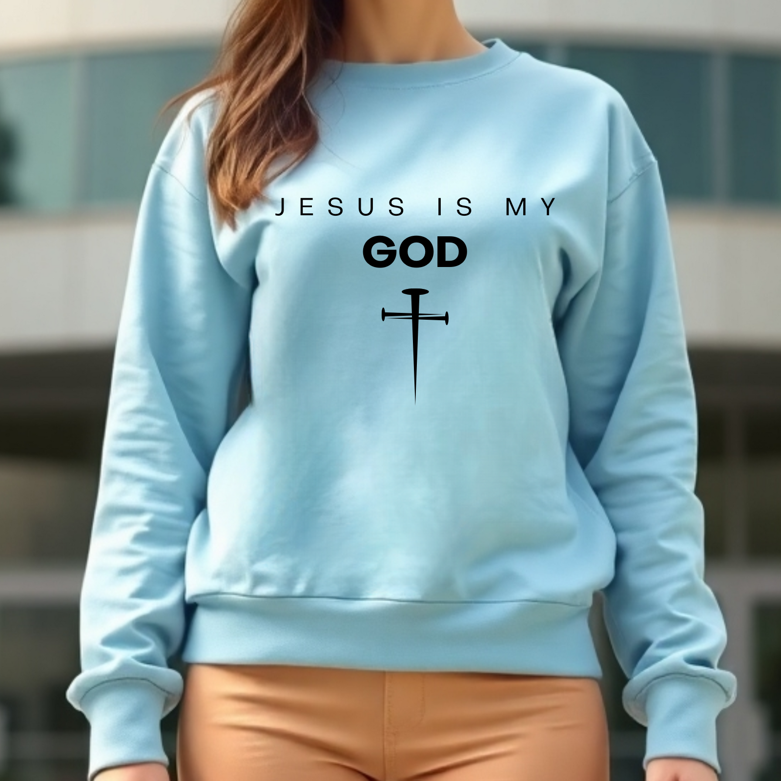 Jesus Is My God digital design on a woman’s blue sweatshirt.