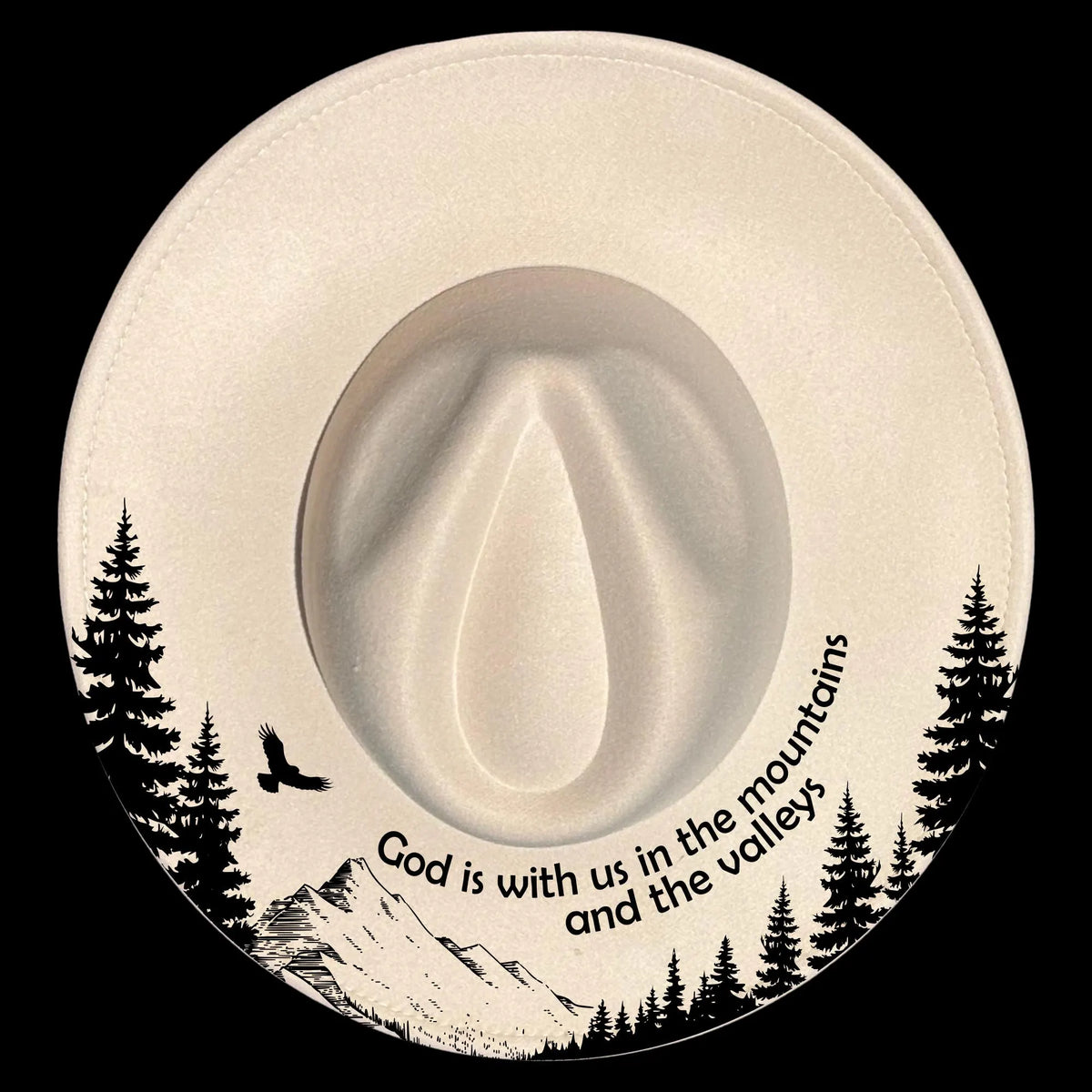White cowboy hat with mountain and tree design and 'God is with us in the mountains and the valleys' text.
