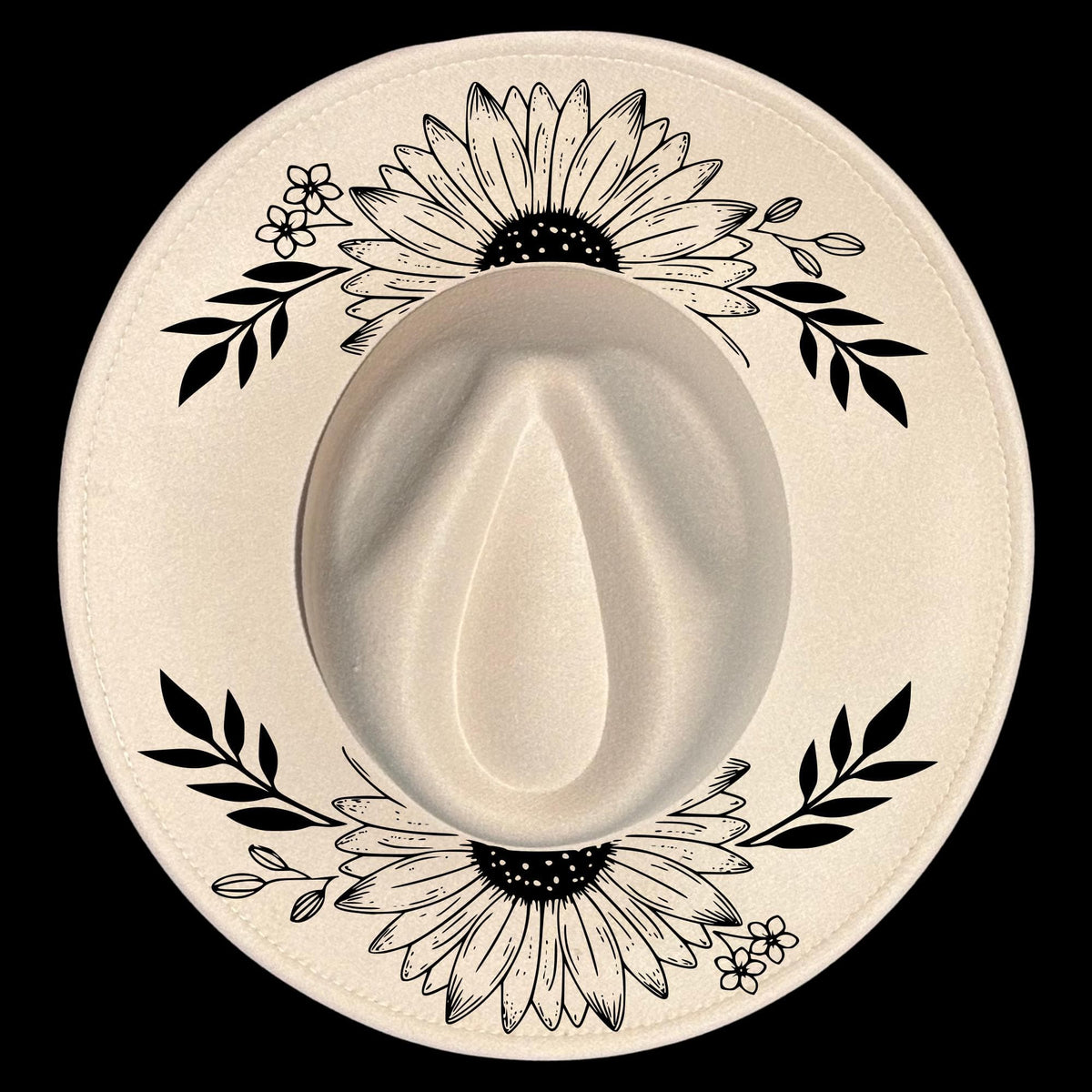 A wide brim hat with black floral and leaf patterns on a white background