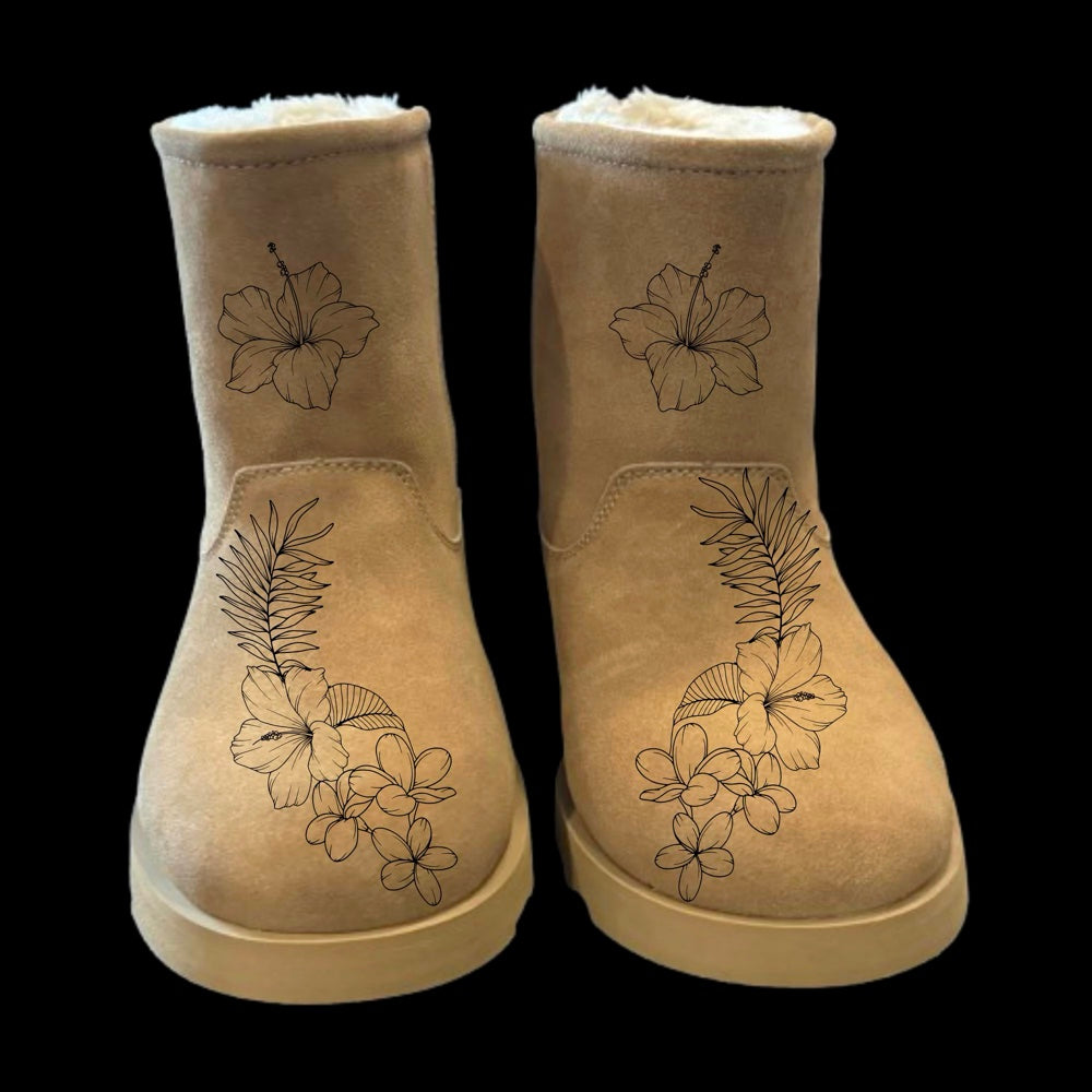A pair of beige boots with a floral design, featuring hibiscus flowers, on a black background.