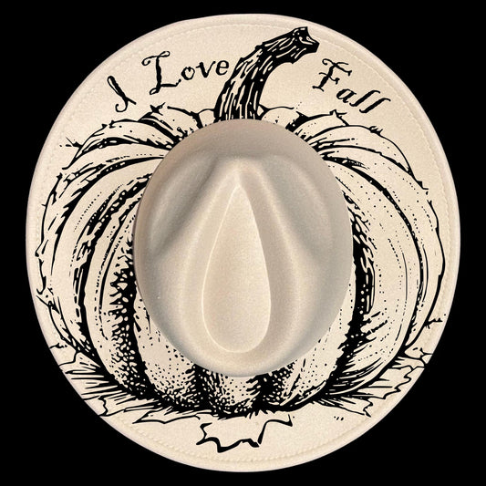 A hat burned design on a wide brim hat of a pumpkin illustration and 'I Love Fall' text.