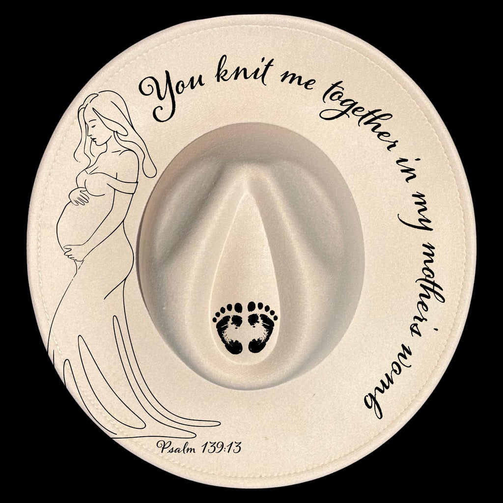 Decorative hat burning design with a pregnant woman illustration, footprints, and "You knit me together in my mother's womb Psalm 139:13" text