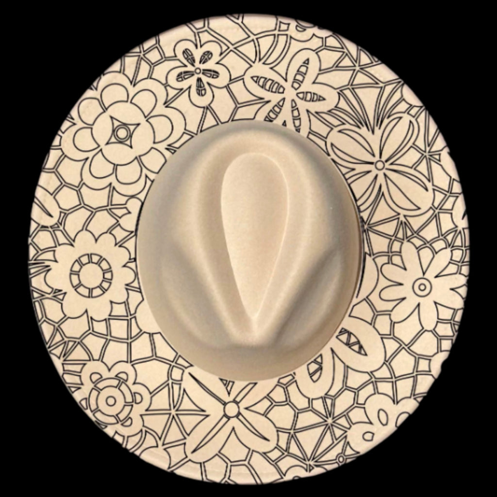 A close-up image of a beige lace overlay hat with a wide brim featuring a boho traceable pattern with floral designs.